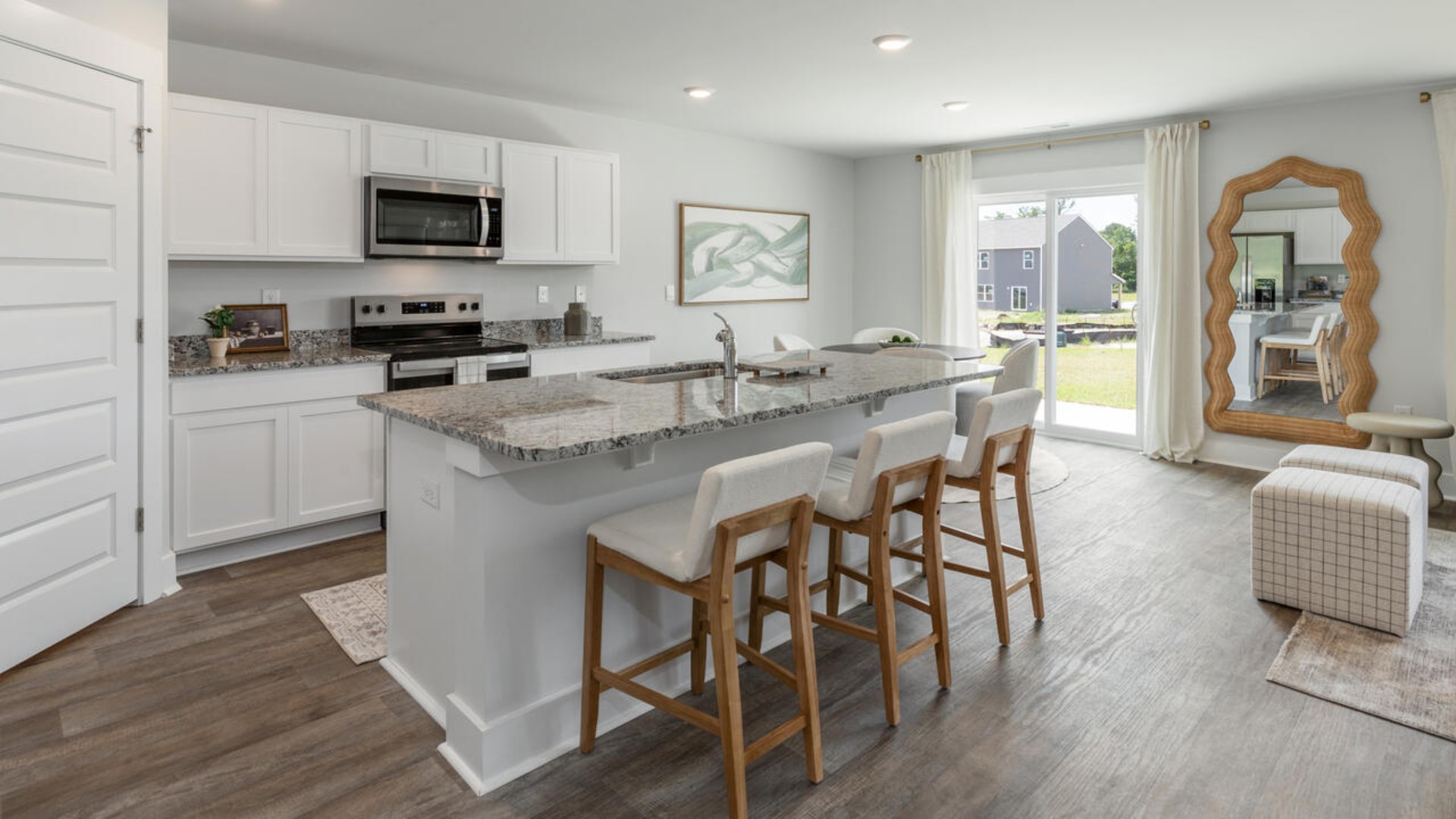 The open-concept kitchen features granite countertops and stainless steel appliances. The kitchen seamlessly connects to the dining and living areas, creating a great space for entertainment.