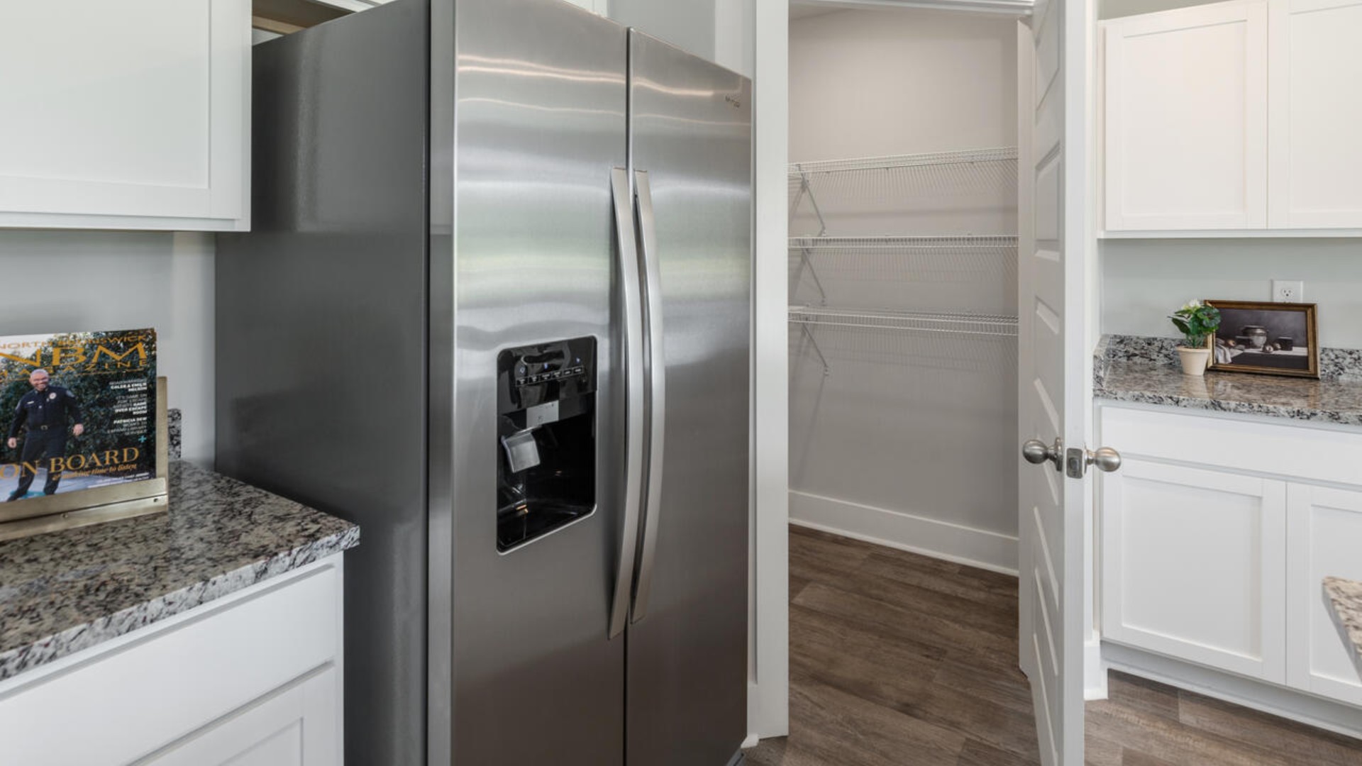 The open-concept kitchen features granite countertops and stainless steel appliances. The kitchen seamlessly connects to the dining and living areas, creating a great space for entertainment.