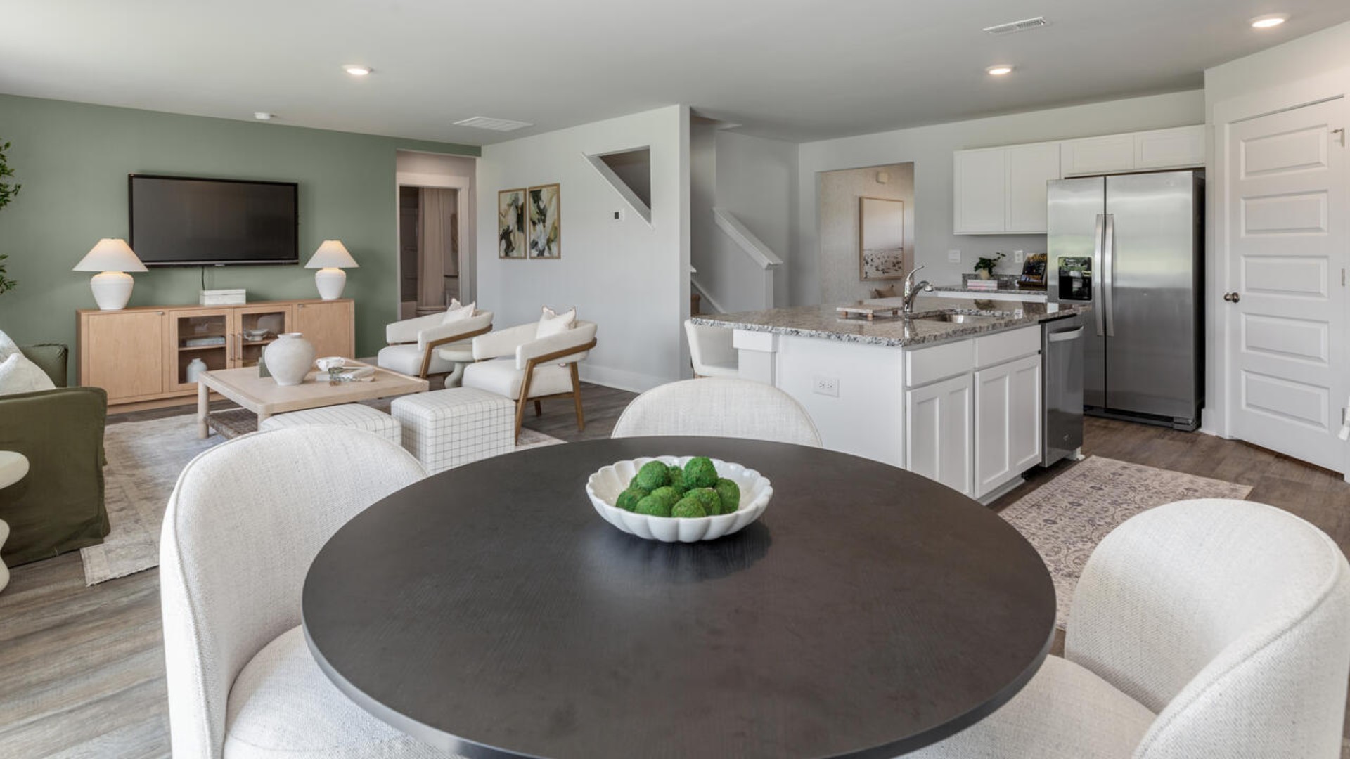 The open-concept kitchen features granite countertops and stainless steel appliances. The kitchen seamlessly connects to the dining and living areas, creating a great space for entertainment.