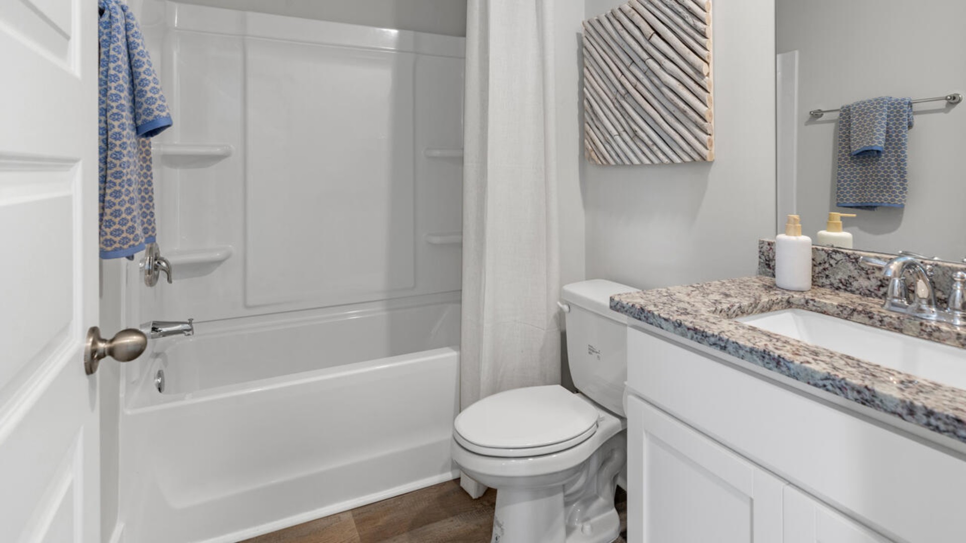 The open-concept kitchen features granite countertops and stainless steel appliances. The kitchen seamlessly connects to the dining and living areas, creating a great space for entertainment.