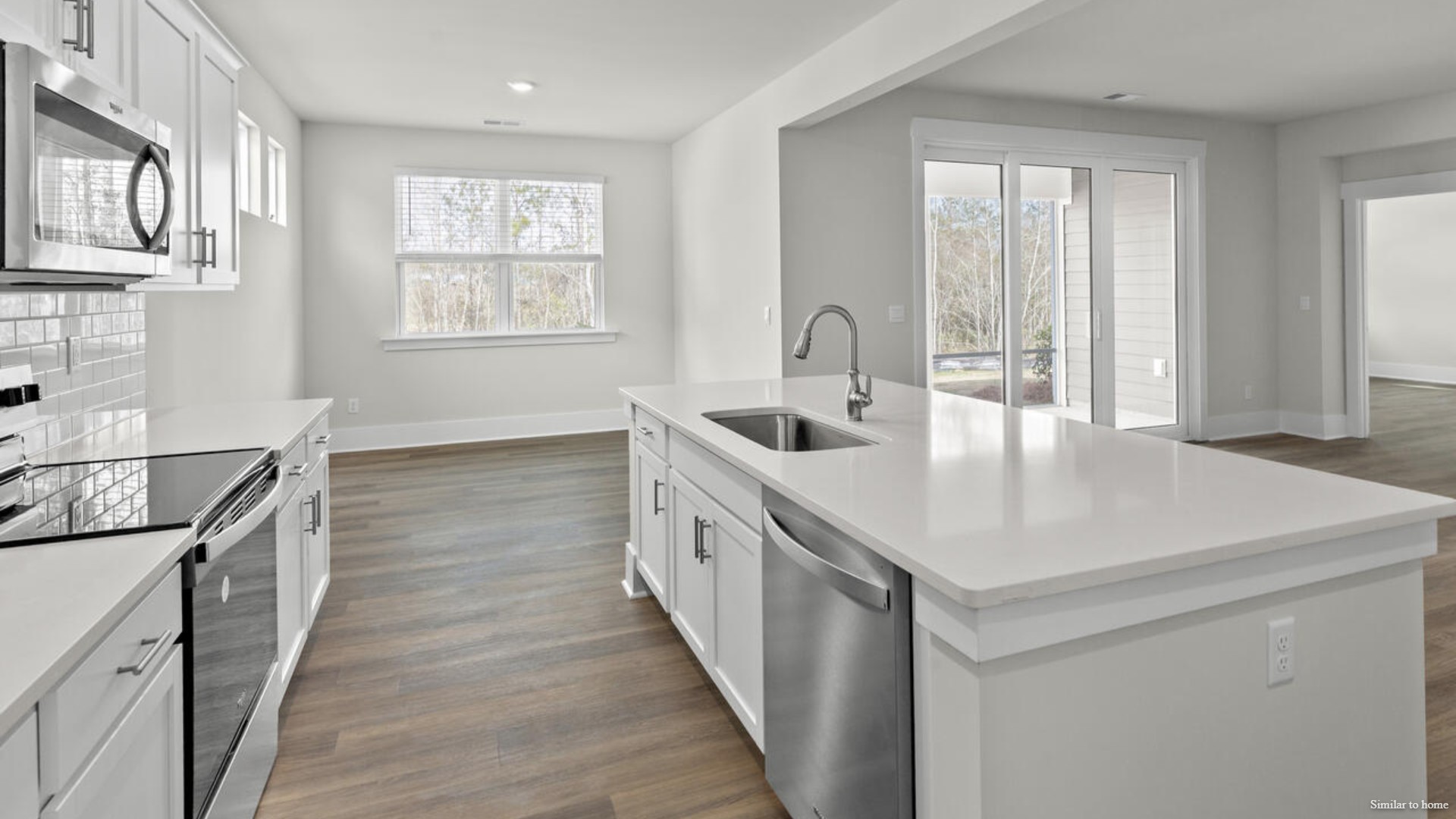 The screened-in patio sits right off of the main dining area and kitchen that features a walk-in pantry, and stainless-steel appliances!