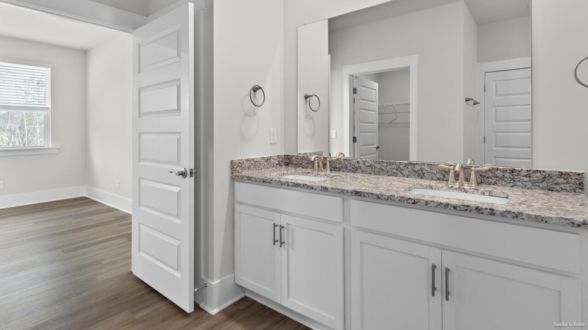 he primary suite features a step-in 5-foot shower and dual vanity