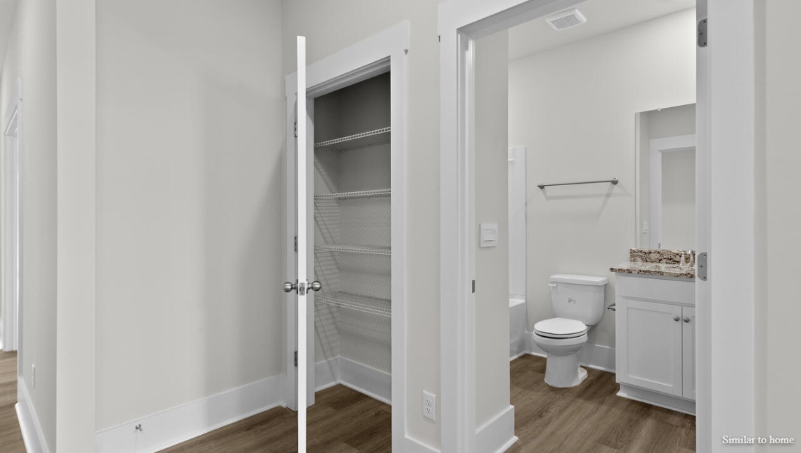 Additional bedrooms are well-sized, with two sharing a bathroom and one having its own for added convenience.