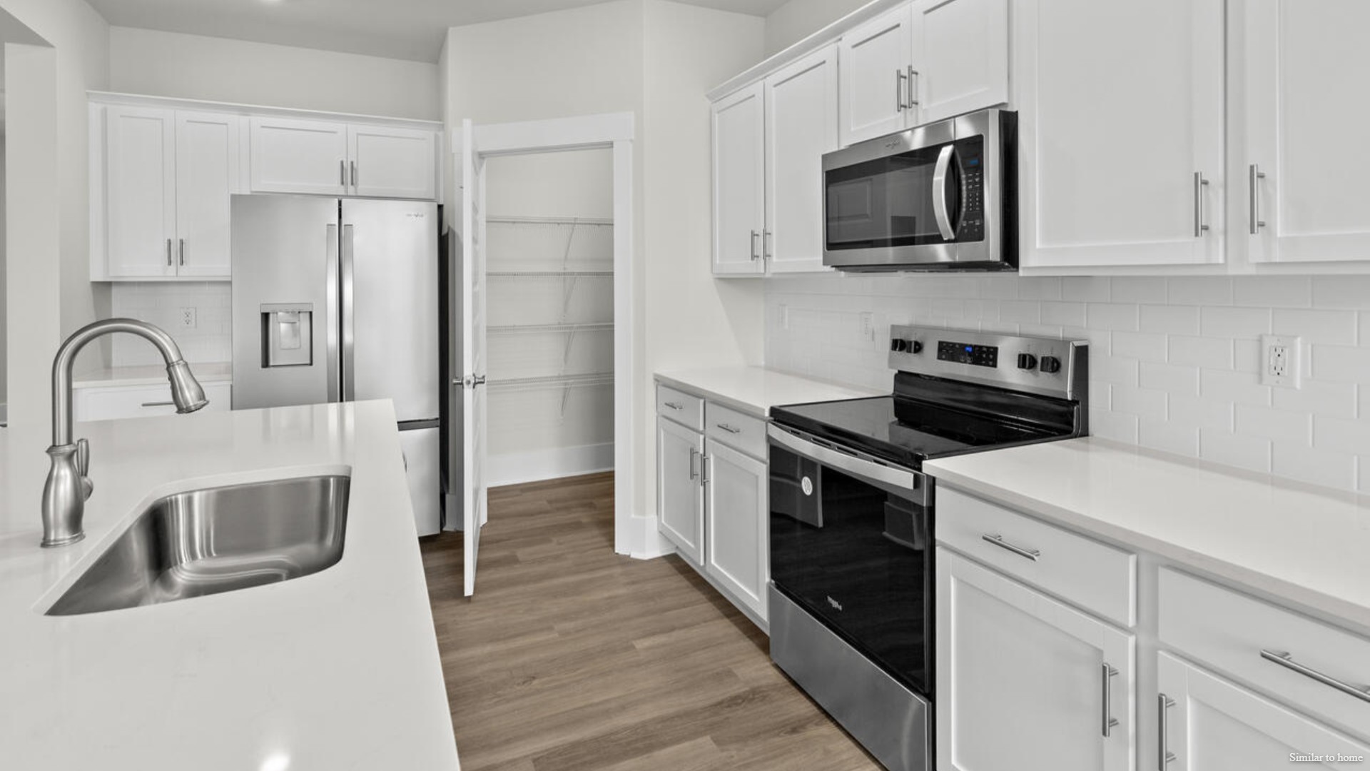 kitchen that features a walk-in pantry, and stainless-steel appliances!