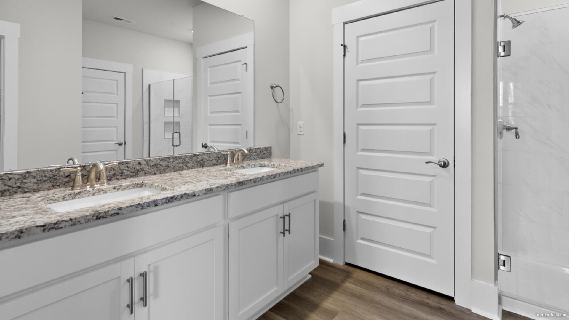 The primary suite features a step-in 5-foot shower and dual vanity