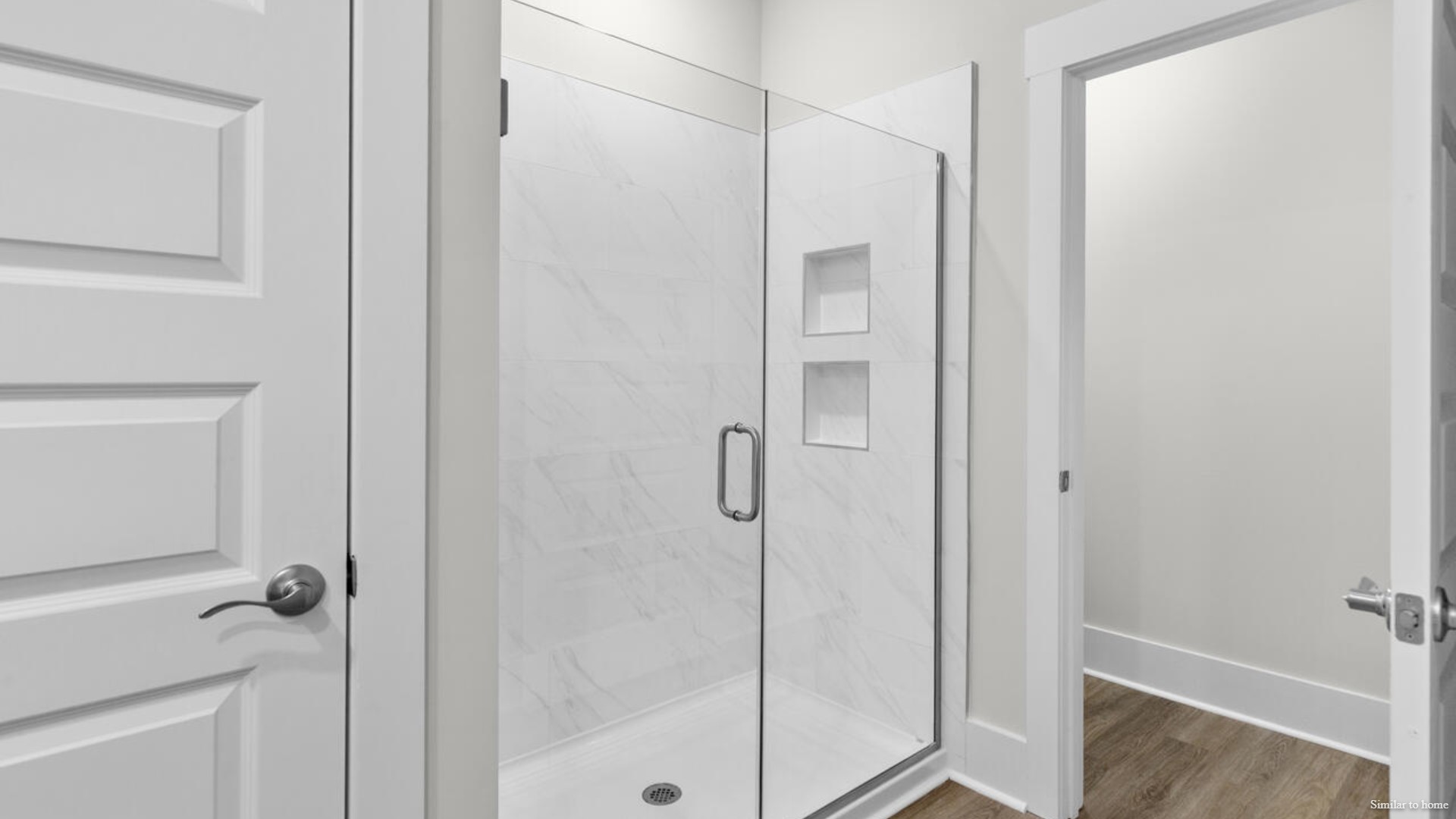 The primary suite features a step-in 5-foot shower and dual vanity
