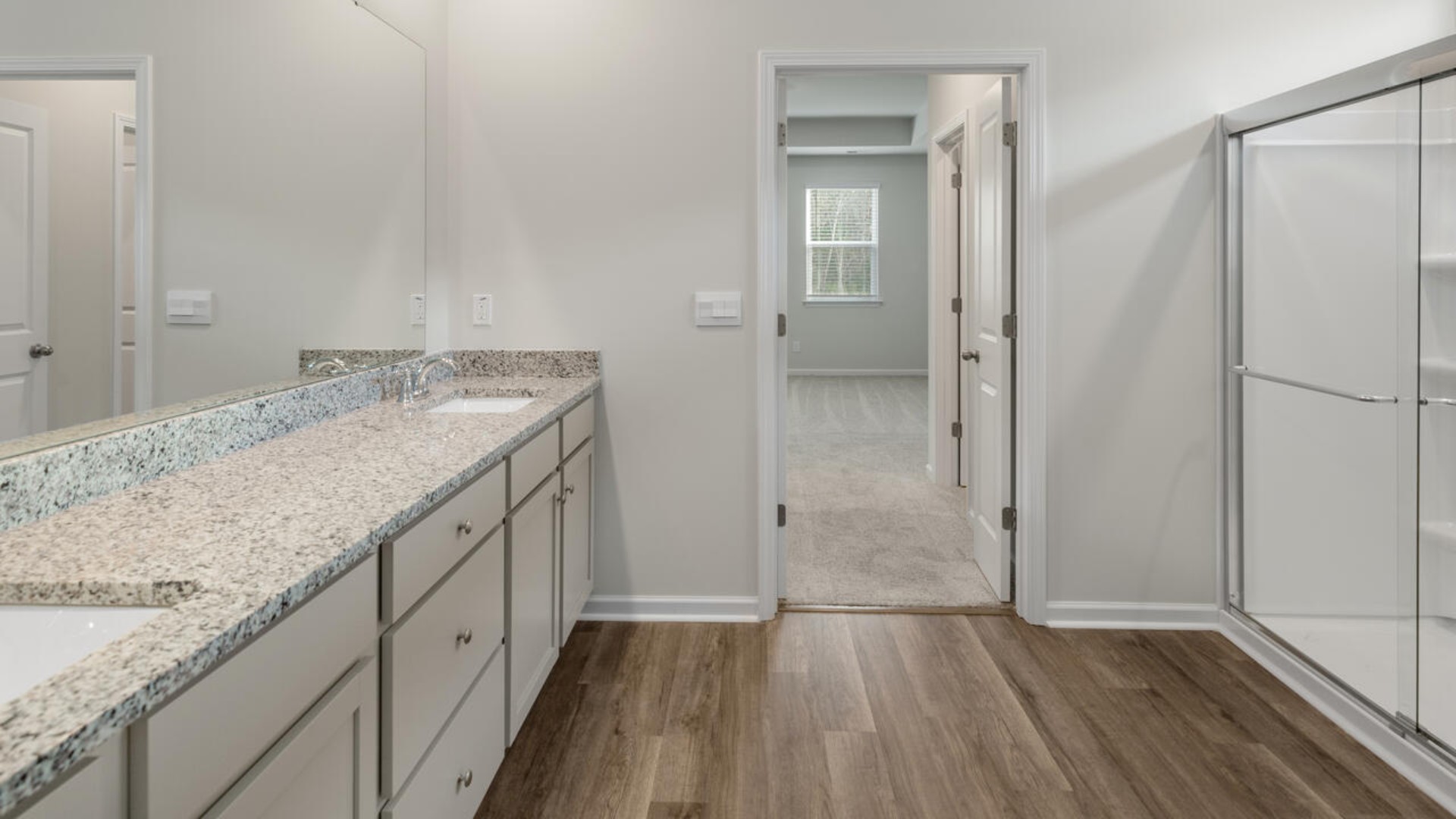 The primary suite features a step-in 5-foot shower and dual vanity. I