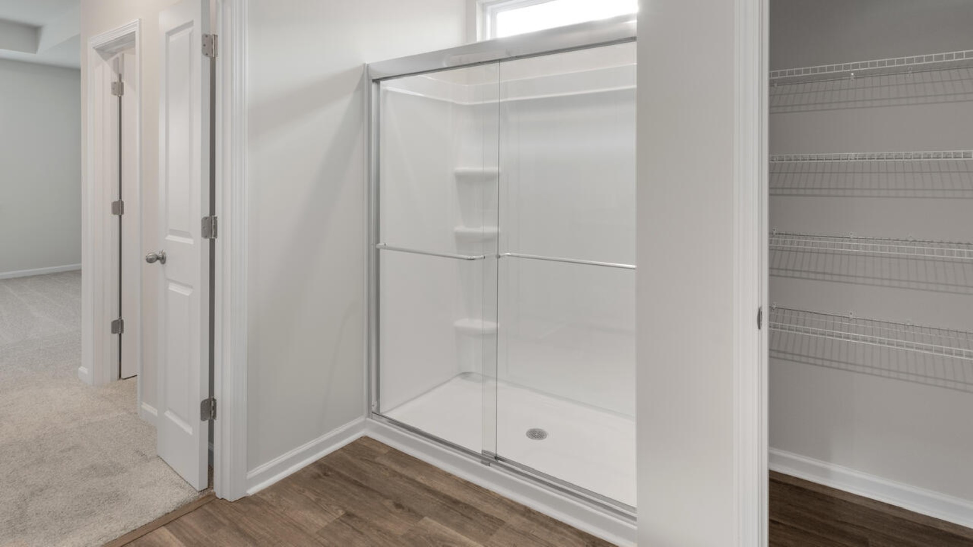 The primary suite features a step-in 5-foot shower and dual vanity. I