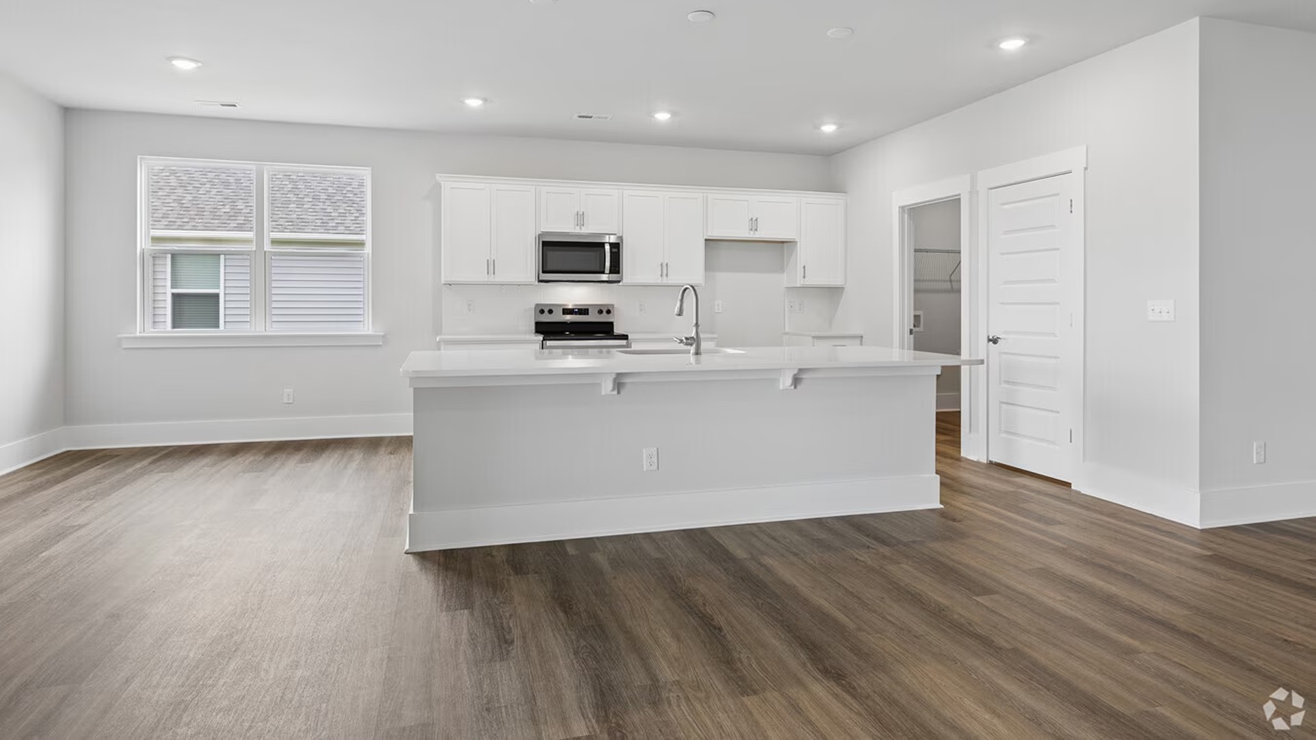 The kitchen is strategically placed for convenience, featuring a large walk-in Pantry and easy access to the Laundry and extra storage areas