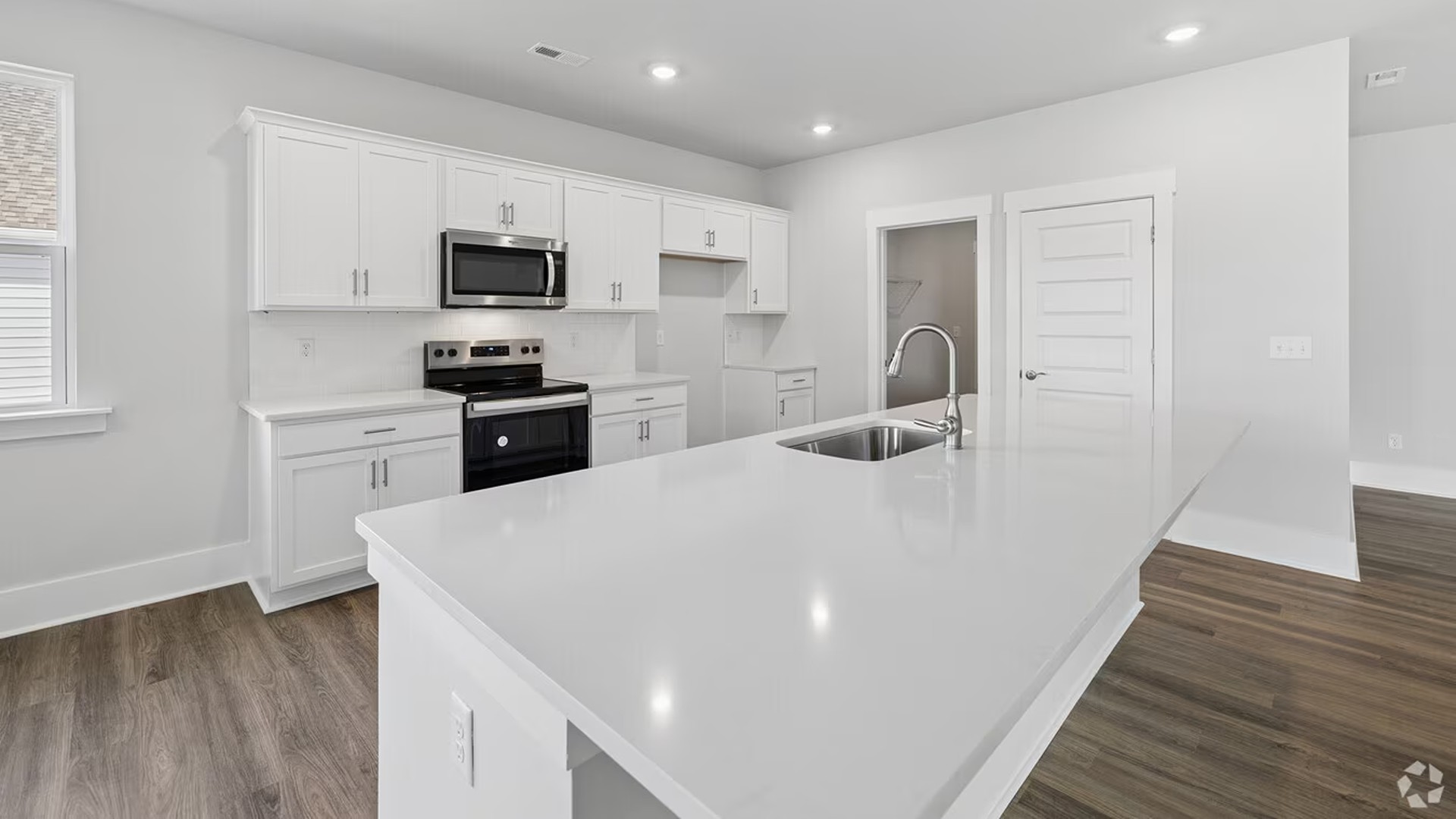 The kitchen is strategically placed for convenience, featuring a large walk-in Pantry and easy access to the Laundry and extra storage areas