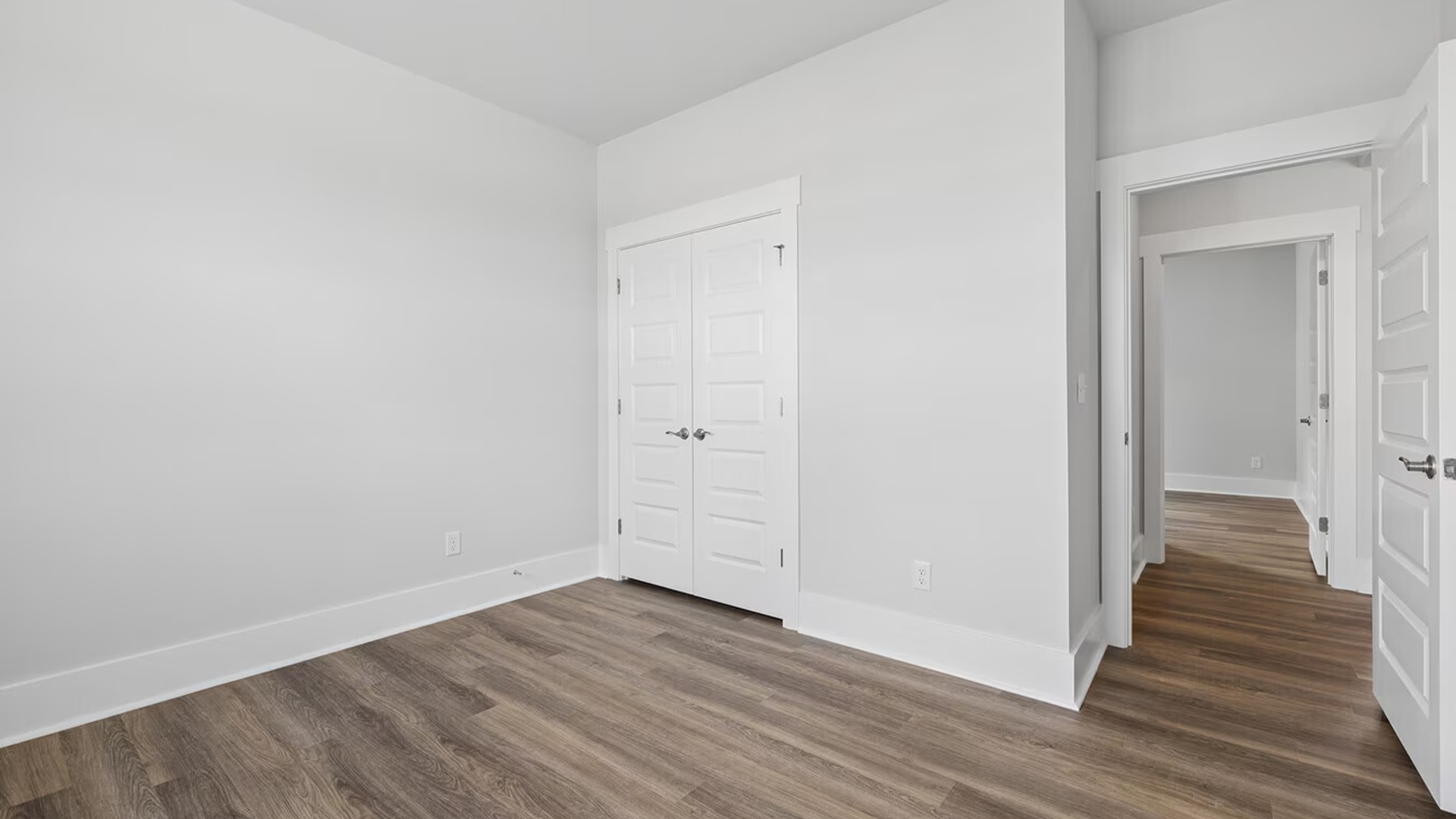 Three additional secondary bedrooms and two full bathrooms are thoughtfully arranged throughout the home, offering fantastic flexibility for guests, a home office, or a growing