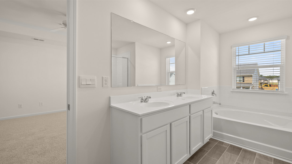 Upstairs there is a generous primary suite with adjoining bath that offers a garden tub, separate shower, dual vanities and plenty of closet space.