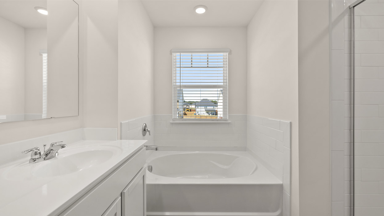 Upstairs there is a generous primary suite with adjoining bath that offers a garden tub, separate shower, dual vanities and plenty of closet space.