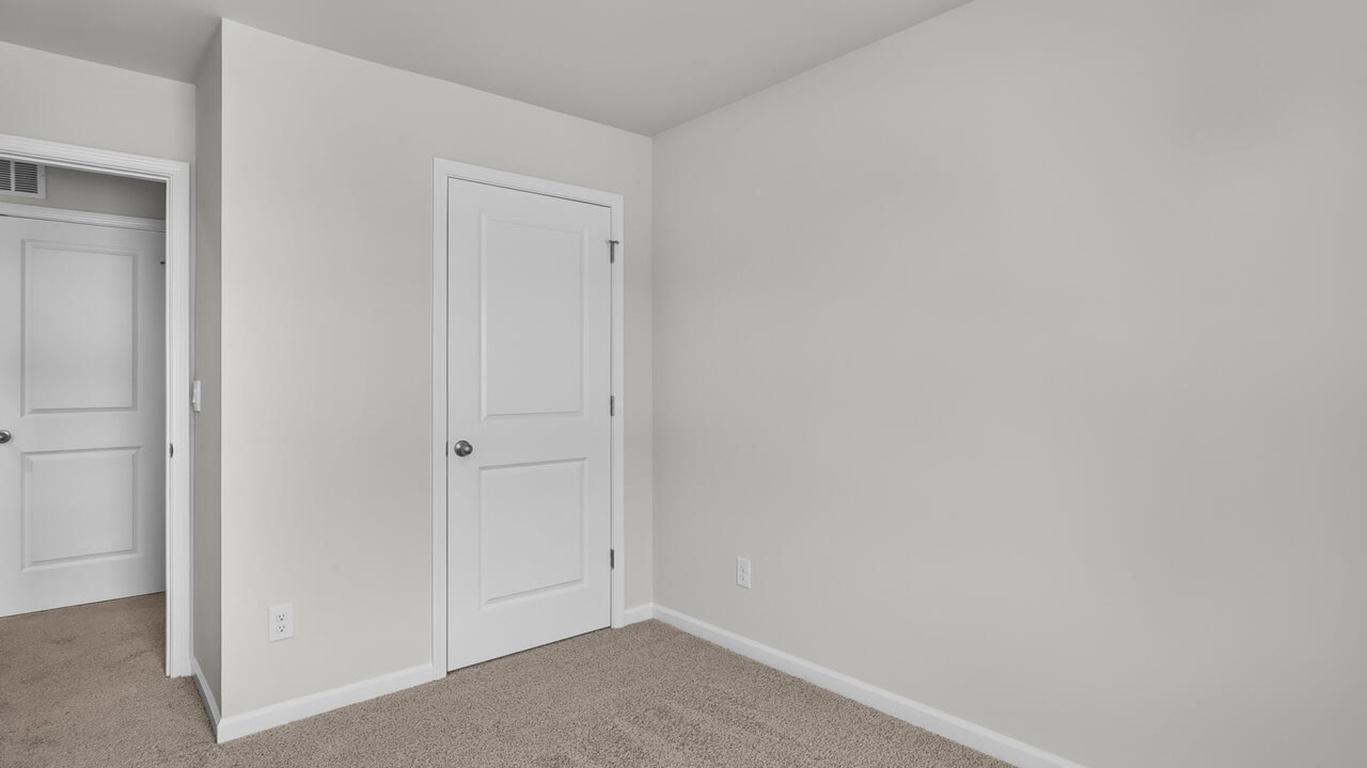 It also includes two additional bedrooms, a shared bathroom, and a laundry room for convenience. The bathrooms are equally elegant, featuring matching granite and a primary suite with a glass shower