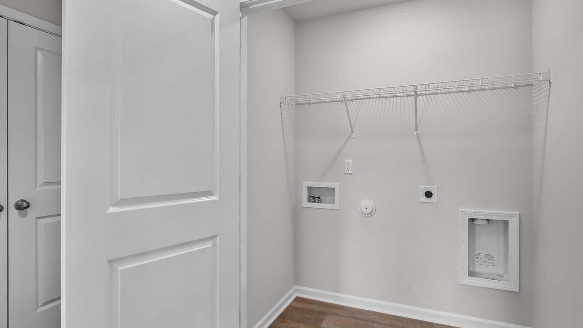 It also includes two additional bedrooms, a shared bathroom, and a laundry room for convenience.