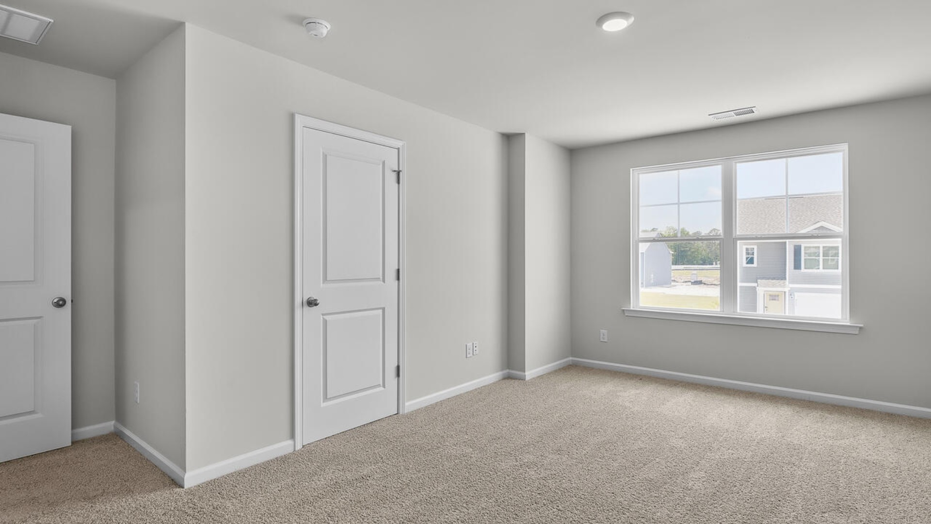 The second floor features the primary bedroom with a walk-in closet and double vanities. It also includes two additional bedrooms, a shared bathroom, and a laundry room for convenience.
