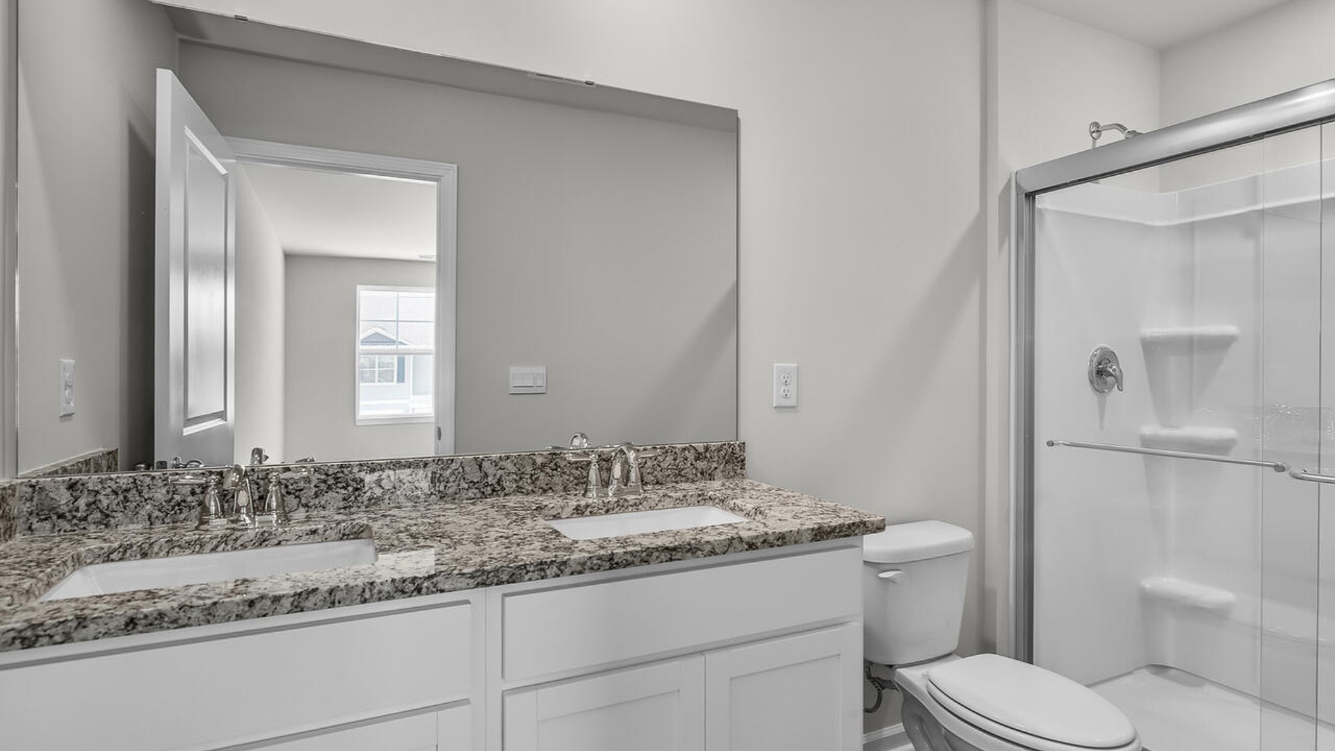 The second floor features the primary bedroom with a walk-in closet and double vanities. It also includes two additional bedrooms, a shared bathroom, and a laundry room for convenience. The bathrooms are equally elegant, featuring matching granite and a primary suite with a glass shower that feels like your own personal spa.