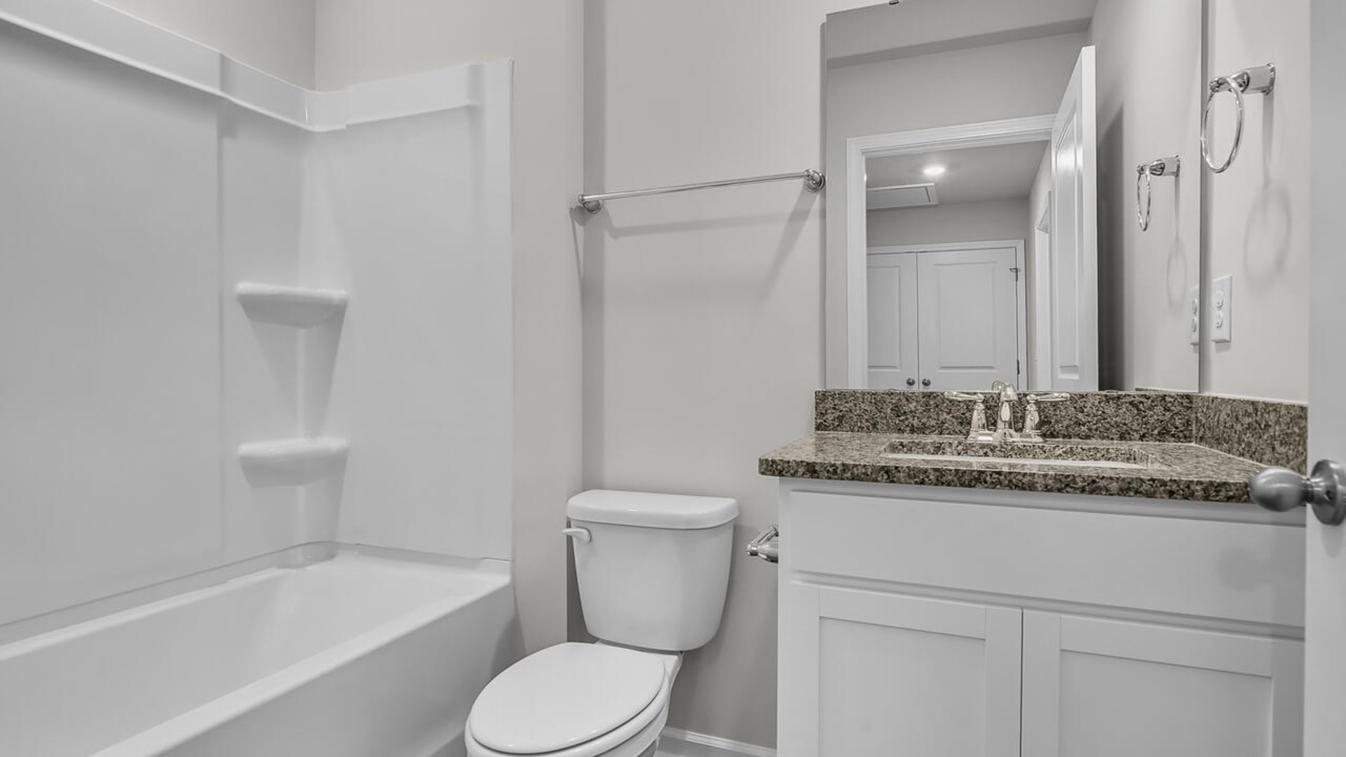 The second floor features the primary bedroom with a walk-in closet and double vanities. It also includes two additional bedrooms, a shared bathroom, and a laundry room for convenience.