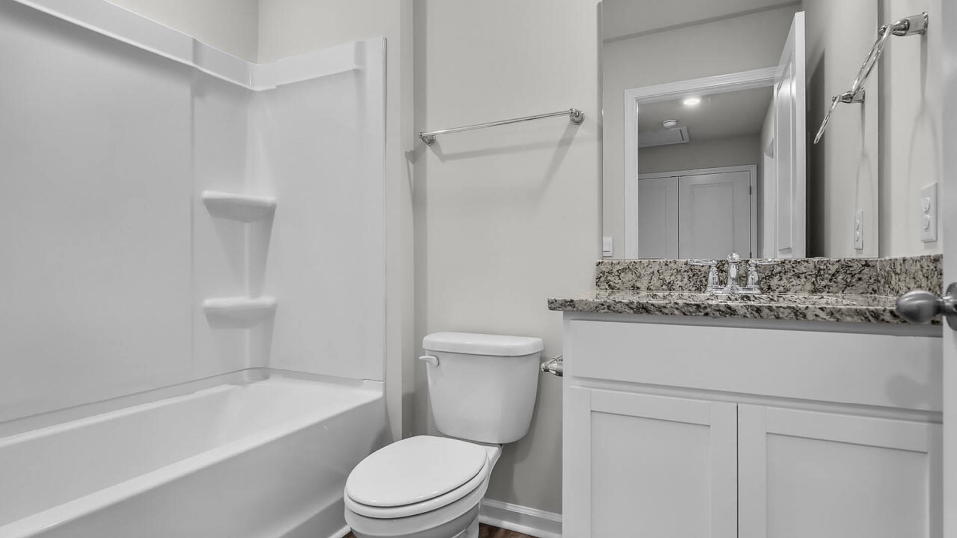 The second floor features the primary bedroom with a walk-in closet and double vanities. It also includes two additional bedrooms, a shared bathroom, and a laundry room