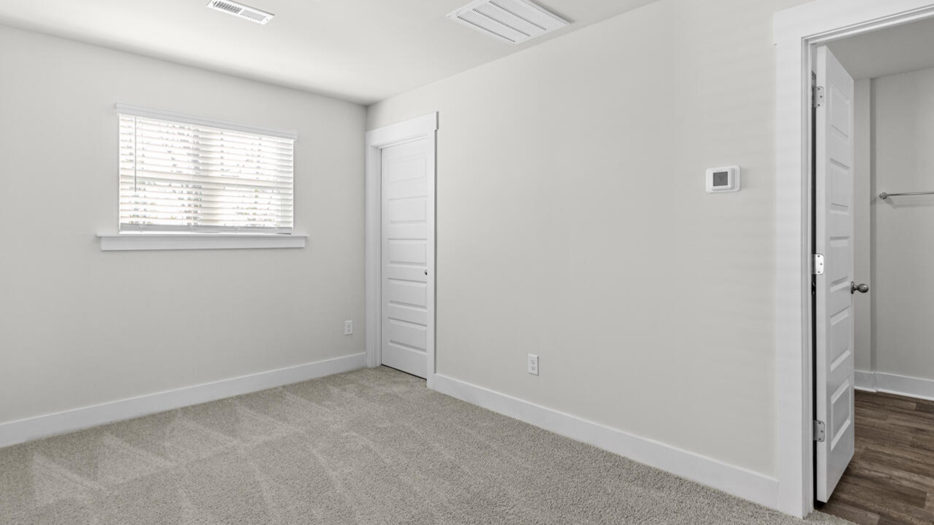 The primary suite is conveniently located just off the living room.