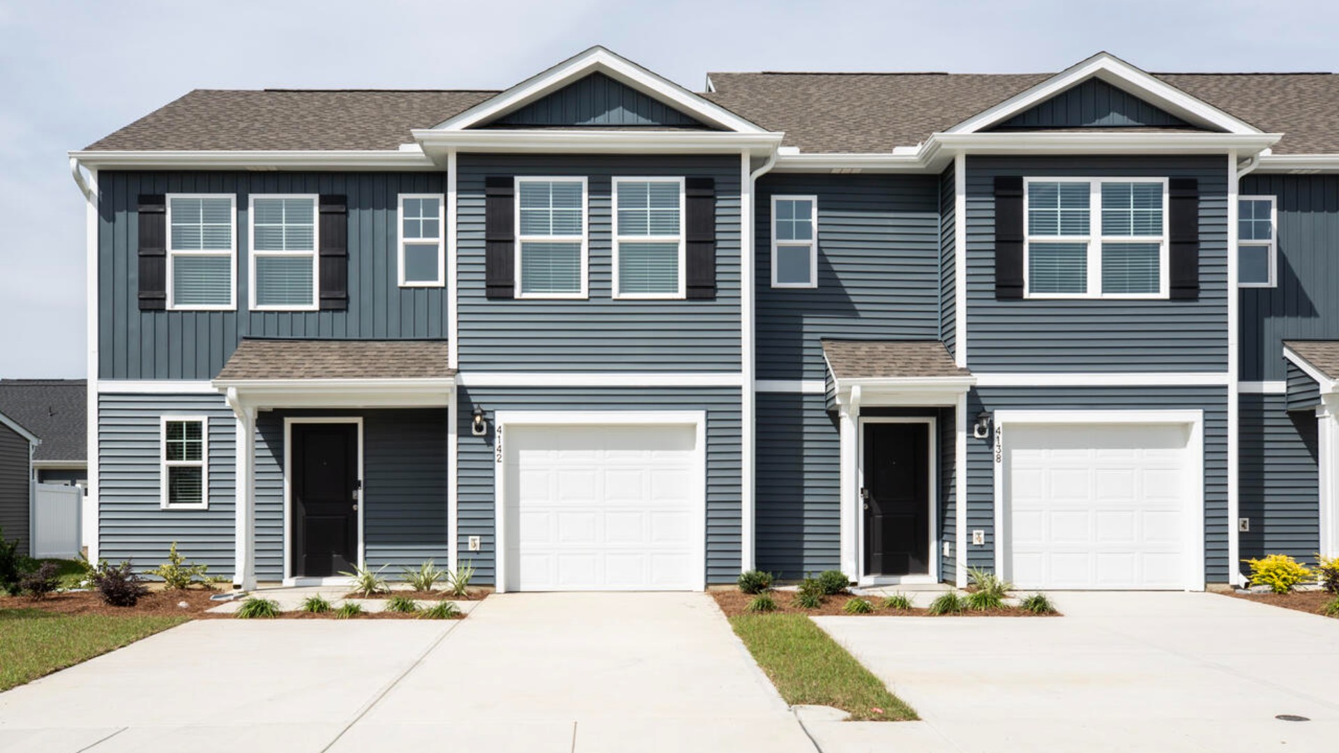 The Norman townhome with the first-floor primary bedroom is a two-story residence with 4 bedrooms and 2.5 baths, 1,763 sq ft, 1-car garage located in Leland, North Carolina in our Townes at SeaBrooke community.