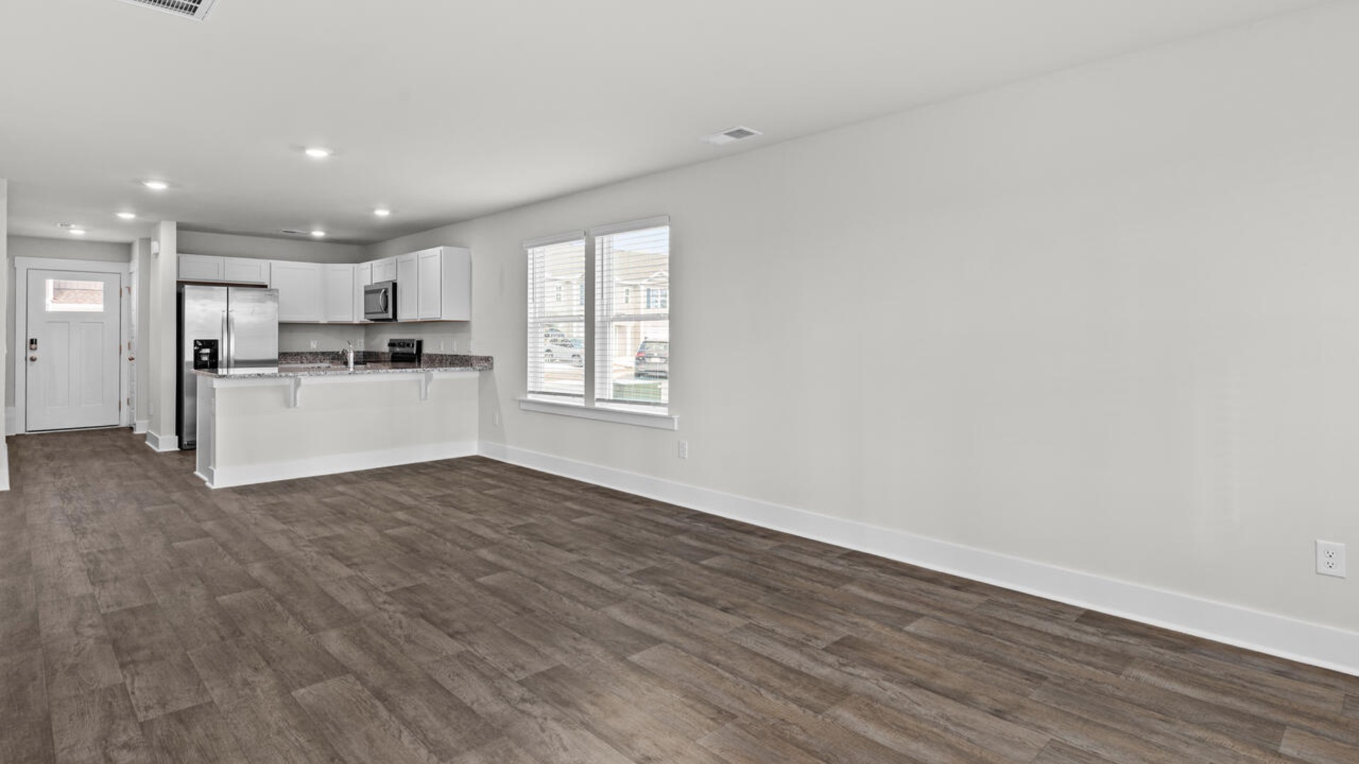 On the first floor, you'll find a spacious kitchen that flows into a light-filled living area, perfect for hosting guests.