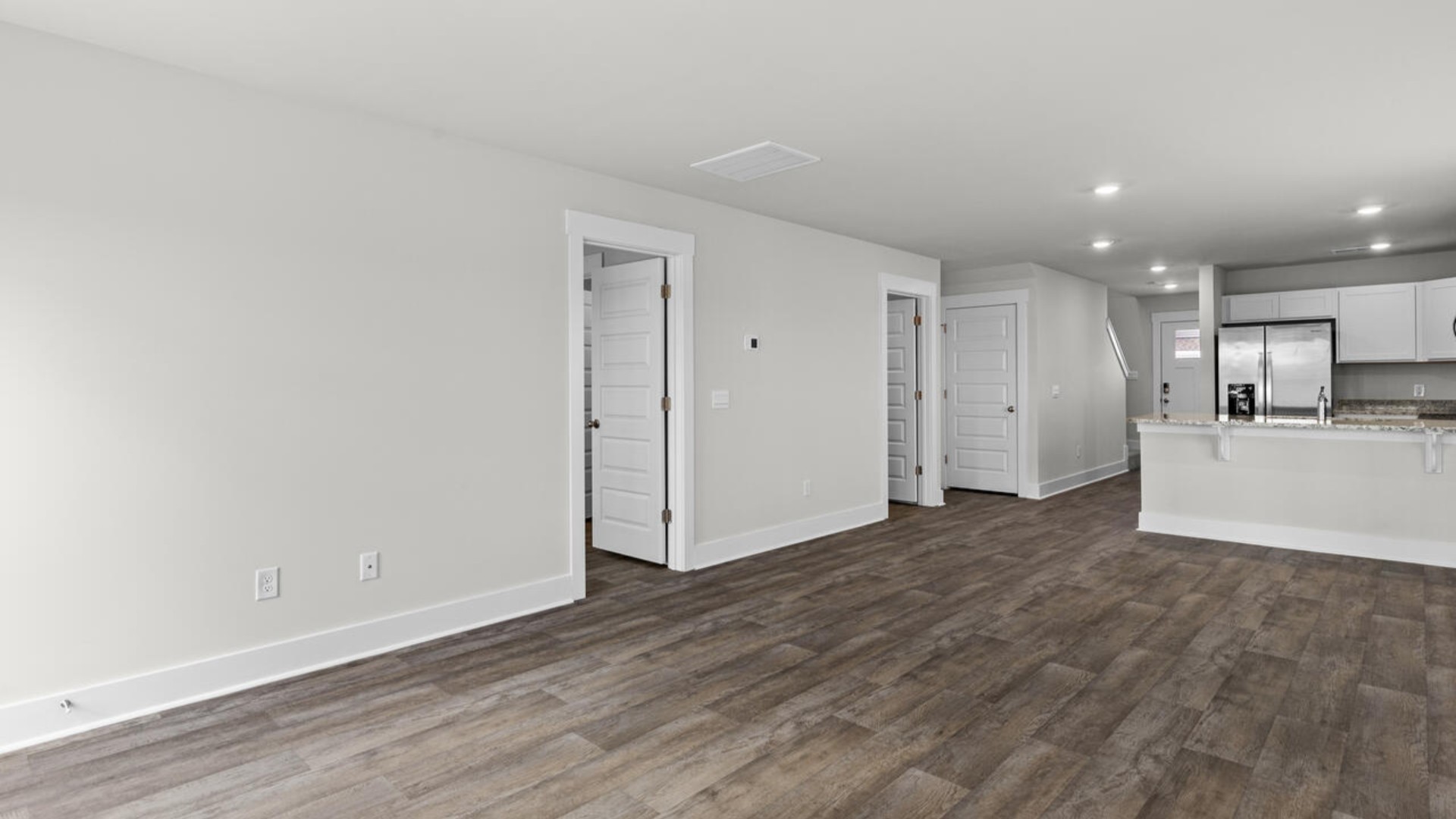 On the first floor, you'll find a spacious kitchen that flows into a light-filled living area, perfect for hosting guests.