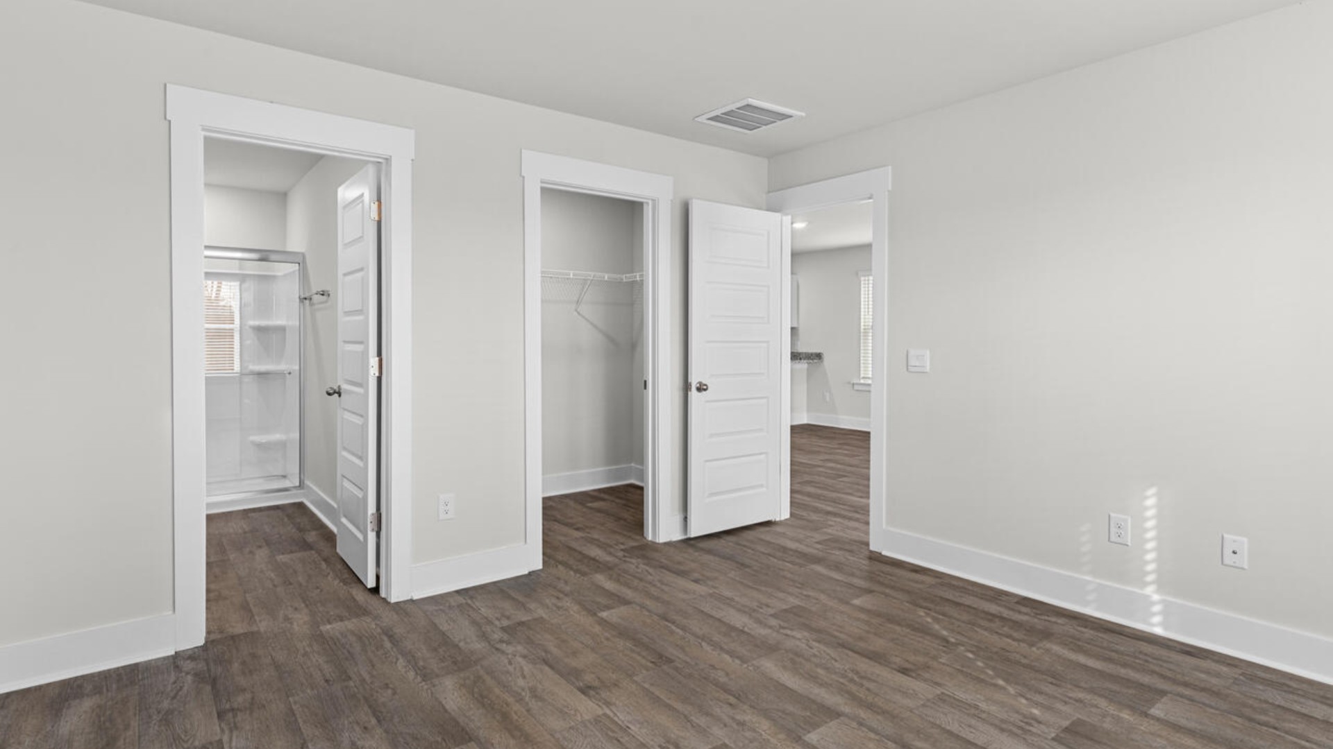 The primary suite is conveniently located just off the living room.