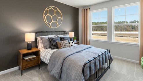 The second floor features the primary bedroom with a walk-in closet and double vanities. It also includes two additional bedrooms, a shared bathroom, and a laundry room for convenience.