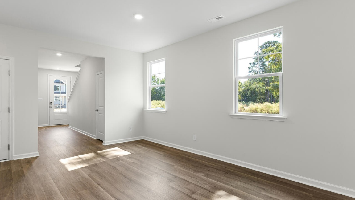 The gourmet kitchen stands out with its elegant granite countertops and stainless steel appliance package. Throughout the home, Luxury Vinyl Plank (LVP) flooring and stain-resistant carpets offer durability and comfort.