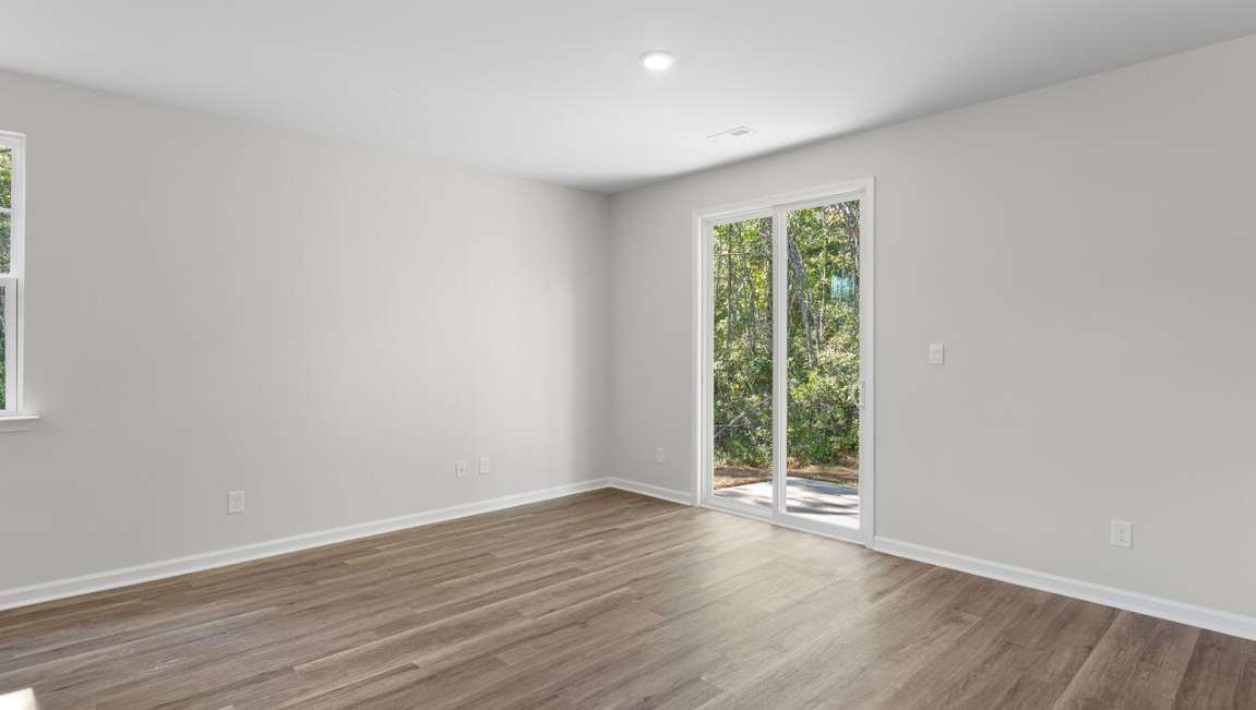 The gourmet kitchen stands out with its elegant granite countertops and stainless steel appliance package. Throughout the home, Luxury Vinyl Plank (LVP) flooring and stain-resistant carpets offer durability and comfort.