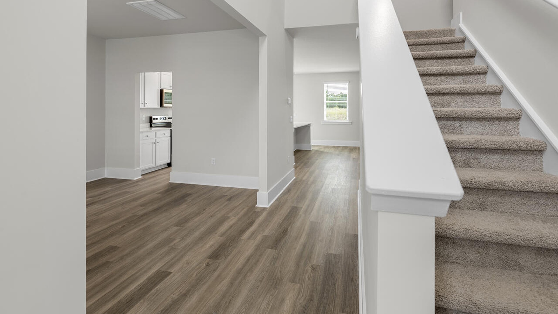 On the first floor, the formal dining room is ideally located next to a spacious open-concept living area and kitchen, allowing for effortless interaction with guests while preparing meals.