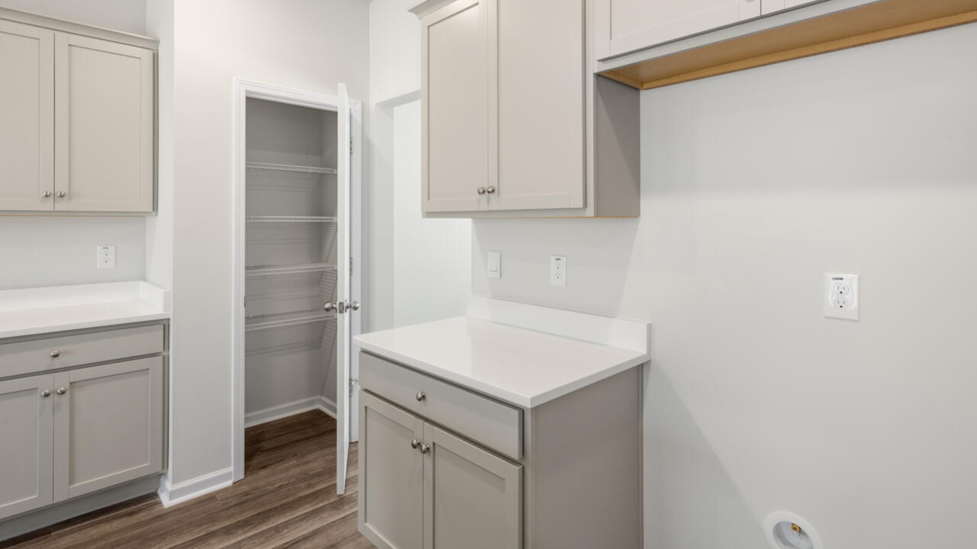 The kitchen features shaker-style cabinets, quartz countertops, and stainless steel appliances, which are sure to both turn heads and make meal prep easy. You’ll never be too far from the action with the living and dining area right there.