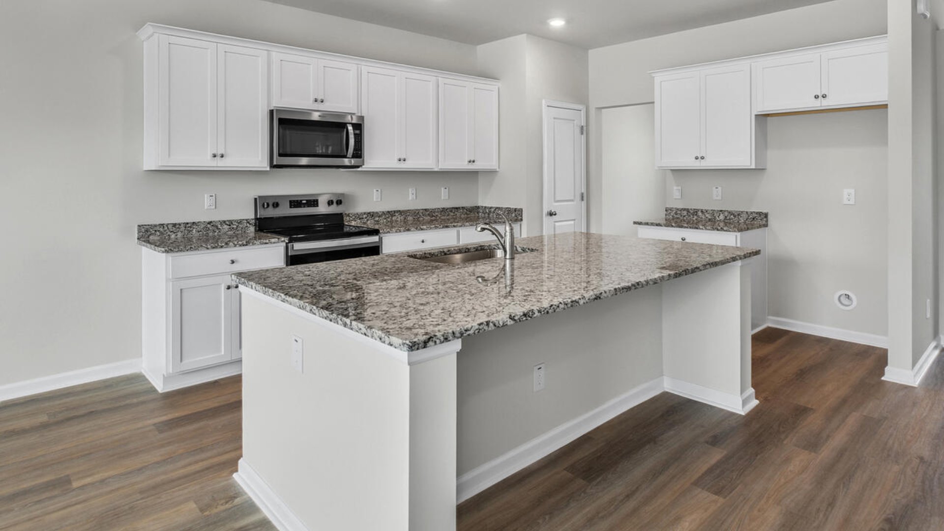 As you enter the home you will find a formal dining room, open concept kitchen and family room with additional seating at the large kitchen island, and a first floor primary bedroom retreat.