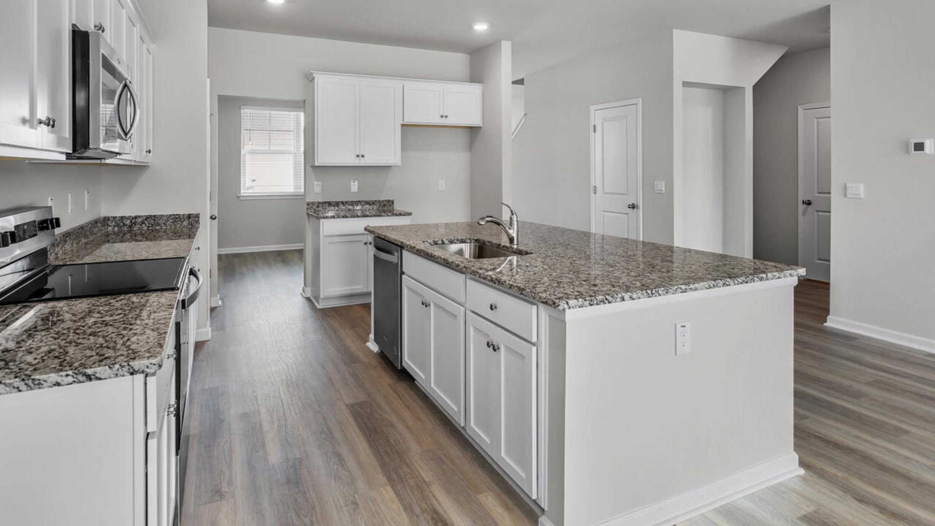 As you enter the home you will find a formal dining room, open concept kitchen and family room with additional seating at the large kitchen island, and a first floor primary bedroom retreat.