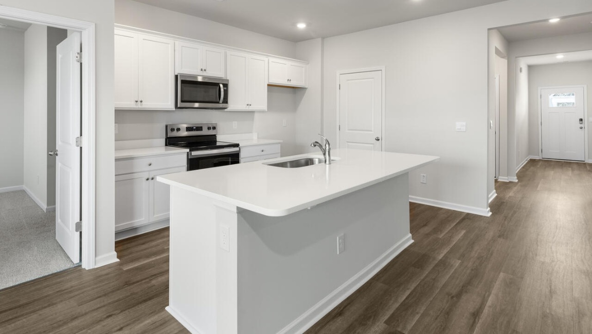 The kitchen features a large island, granite countertops, and stainless steel appliances, which are sure to both turn heads and make meal prep easy. You’ll never be too far from the action with the living and dining area right there.