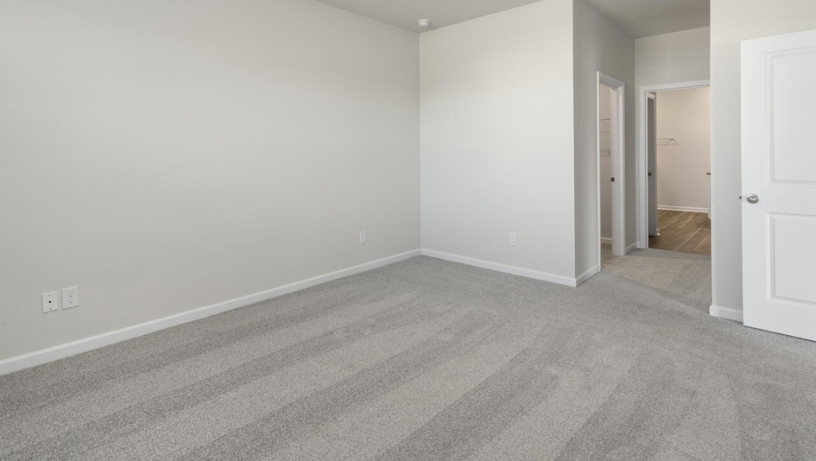 The Primary Suite offers a massive closet and a luxurious bathroom with a walk-in shower, linen closet, and dual vanity.