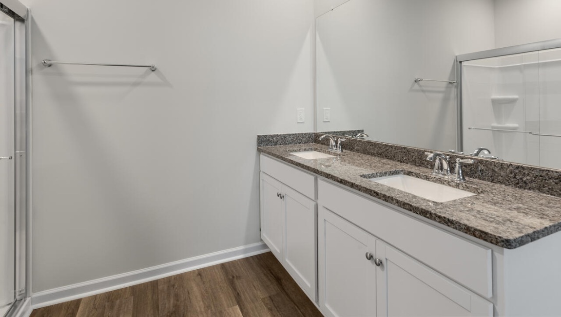 The Primary Suite offers a massive closet and a luxurious bathroom with a walk-in shower, linen closet, and dual vanity.