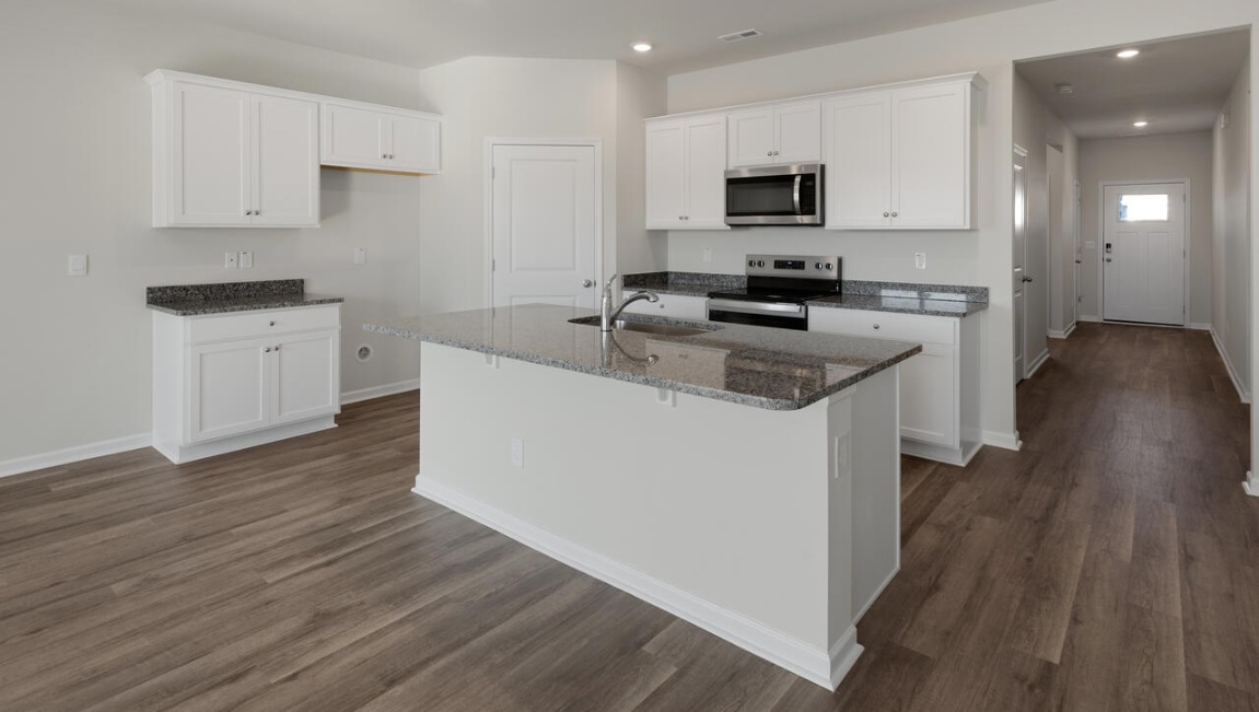 The kitchen features beautiful cabinets, granite countertops, and stainless steel appliances, which are sure to both turn heads and make meal prep easy.