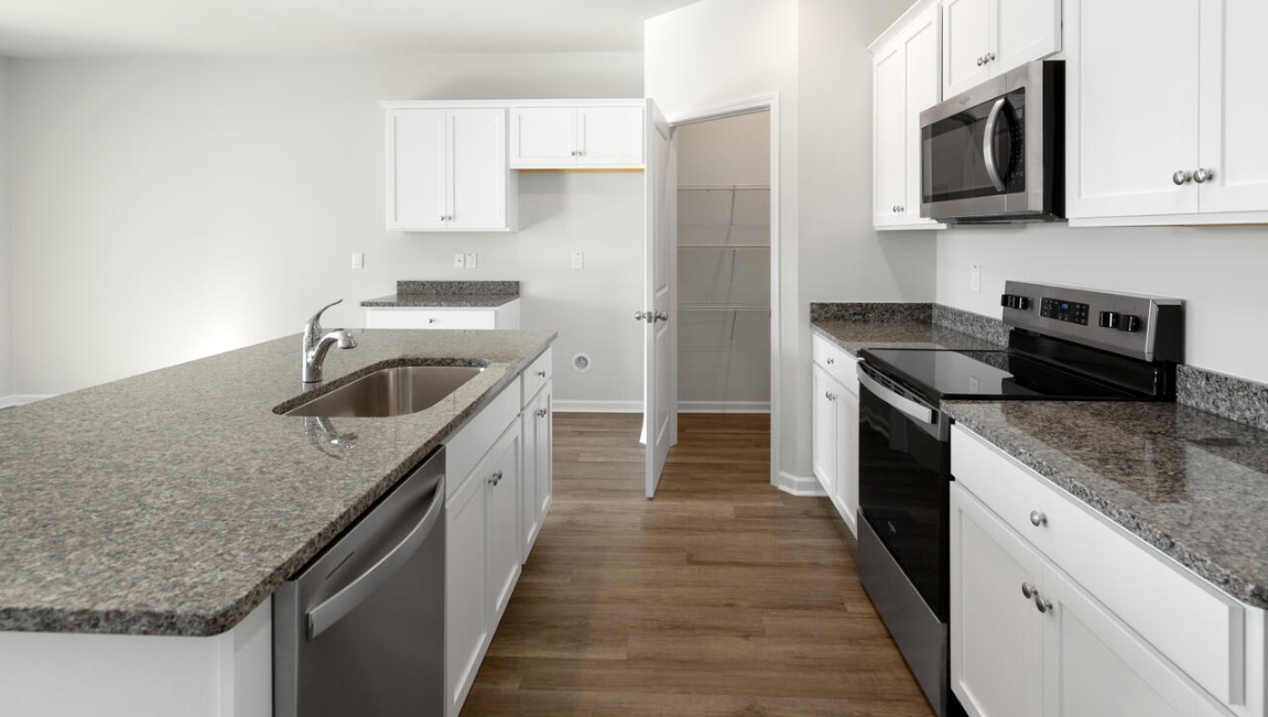 The kitchen features beautiful cabinets, granite countertops, and stainless steel appliances, which are sure to both turn heads and make meal prep easy.