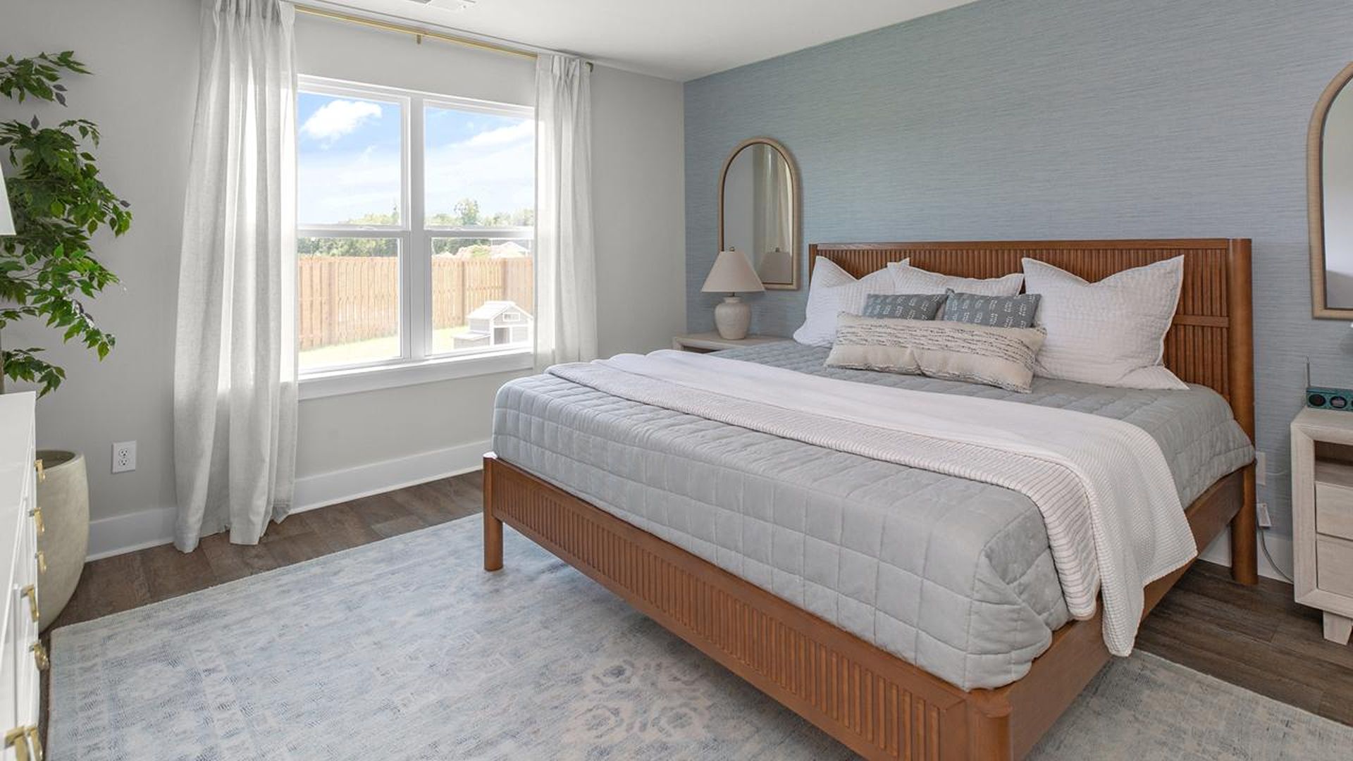 The Primary Suite offers a massive closet and a luxurious bathroom with a walk-in shower, linen closet, and dual vanity