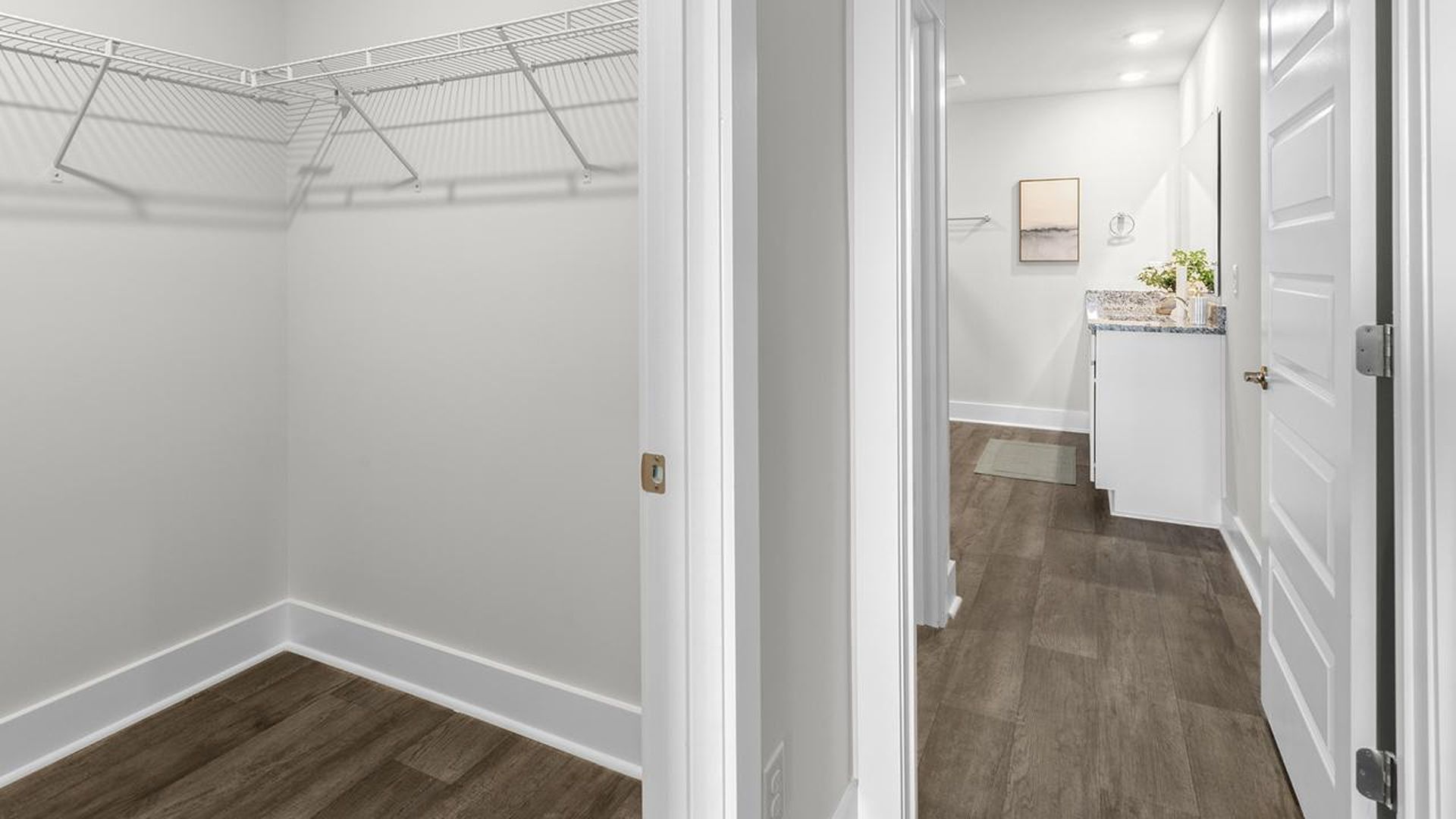 The Primary Suite offers a massive closet and a luxurious bathroom with a walk-in shower, linen closet, and dual vanity