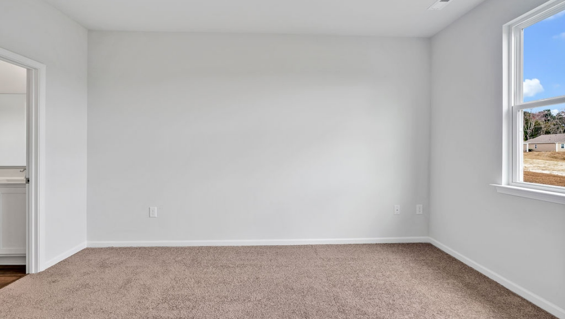 At the back, the Primary Suite provides privacy with a large walk-in closet and walk-in shower. This floor plan combines comfort and convenience, making it a great choice for those seeking an open layout.