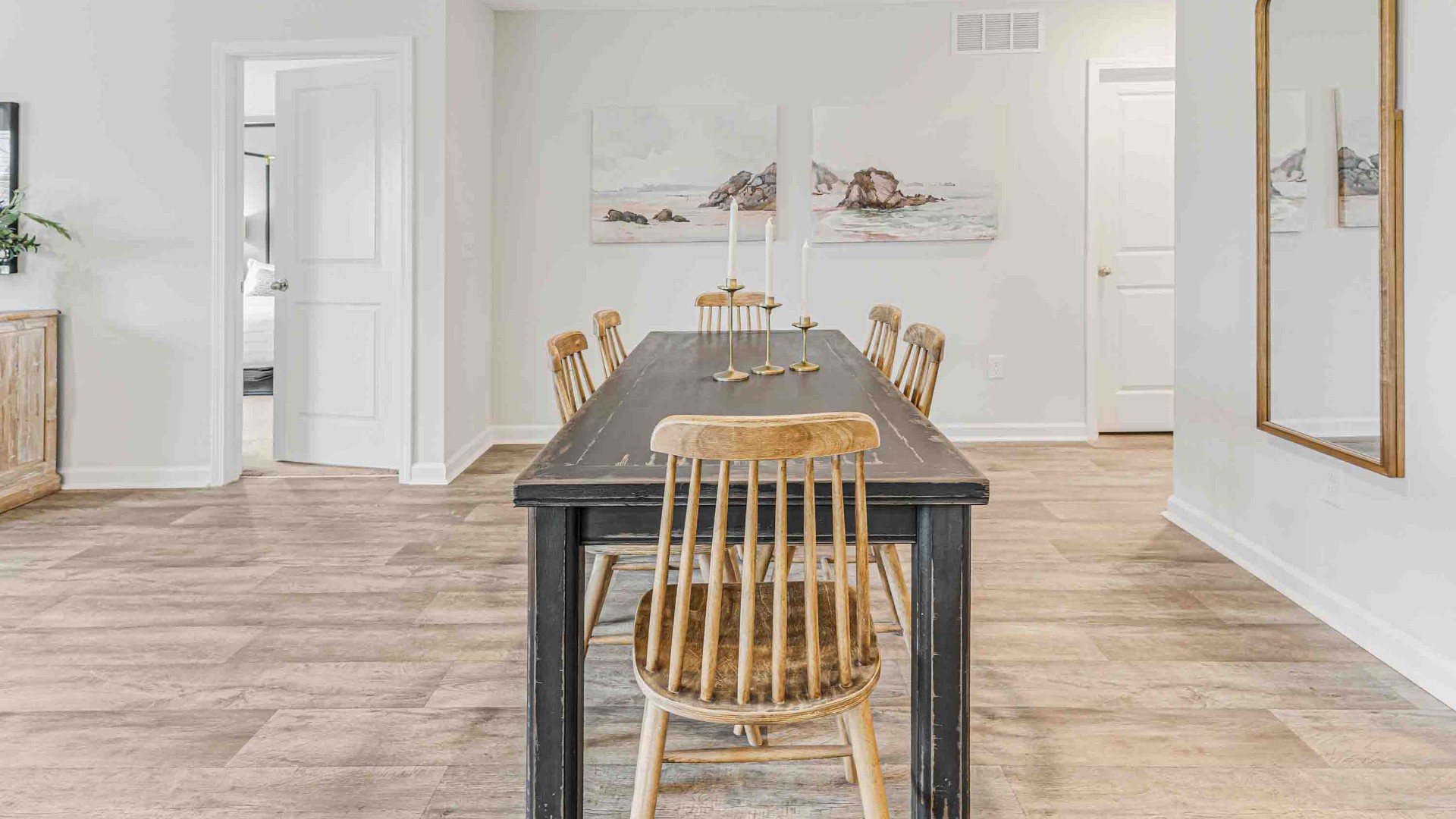 The open-concept family room, kitchen, and dining area feature granite countertops, stainless steel appliances, including a smooth-top range, dishwasher, and overhead microwave.