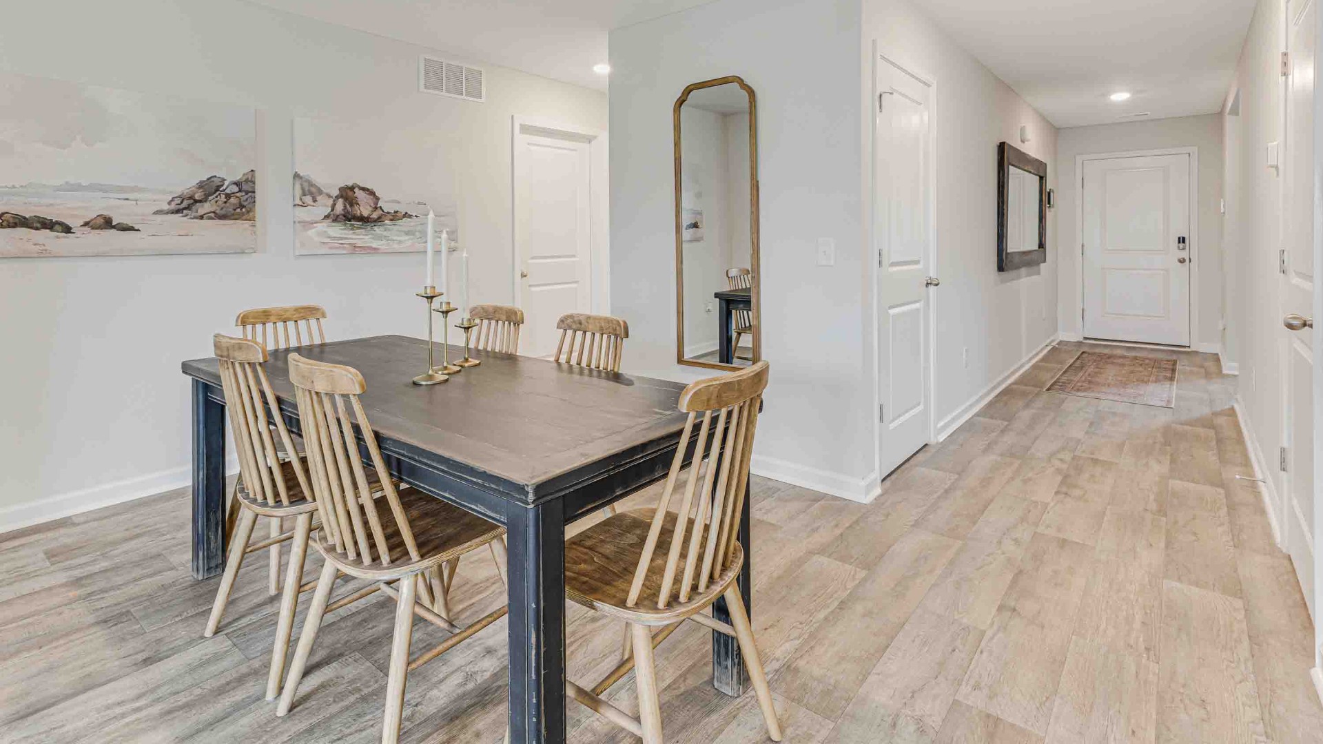 The open-concept family room, kitchen, and dining area feature granite countertops, stainless steel appliances, including a smooth-top range, dishwasher, and overhead microwave.