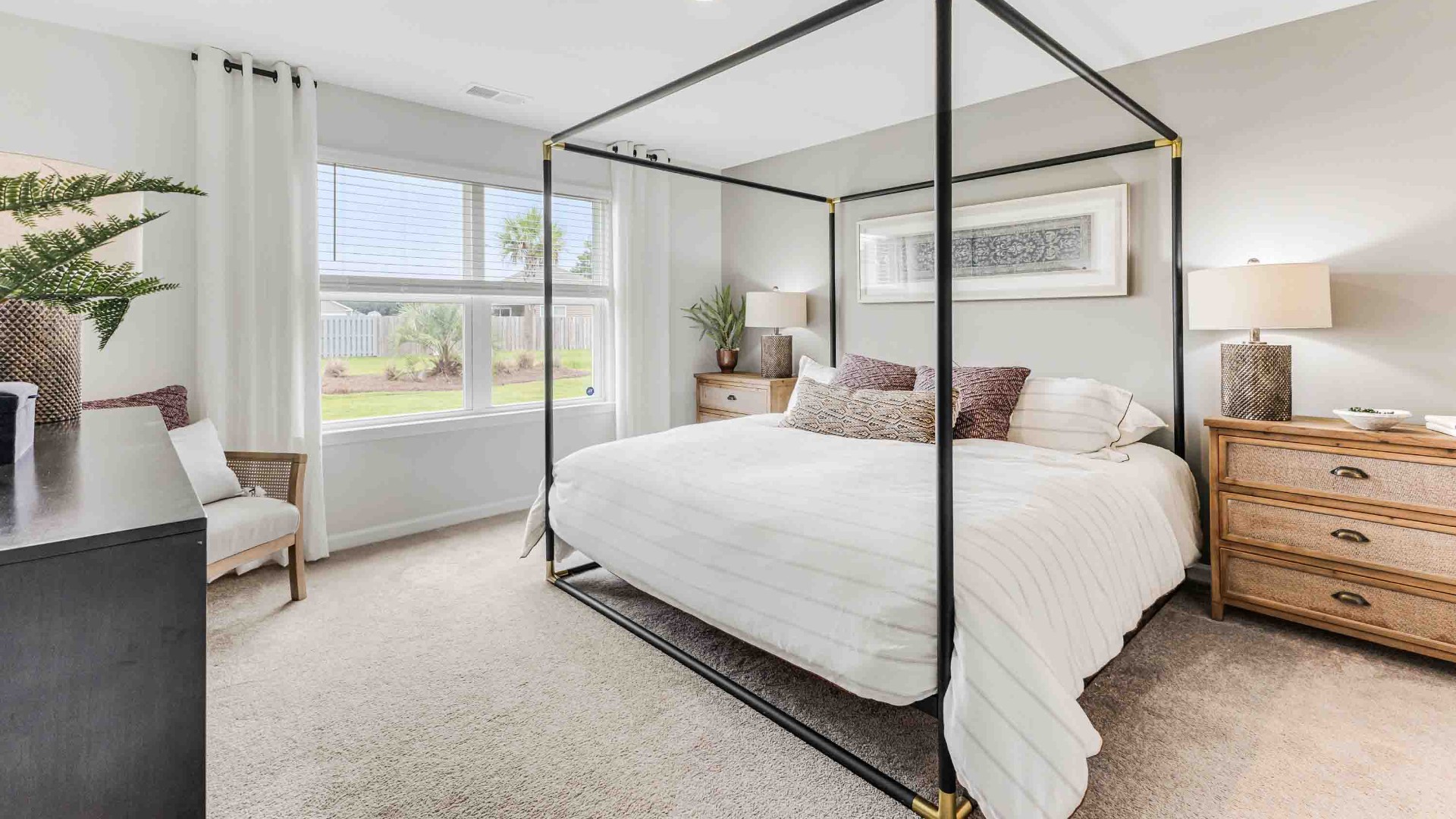 At the back, the Primary Suite provides privacy with a large walk-in closet and walk-in shower. This floor plan combines comfort and convenience, making it a great choice for those seeking an open layout.