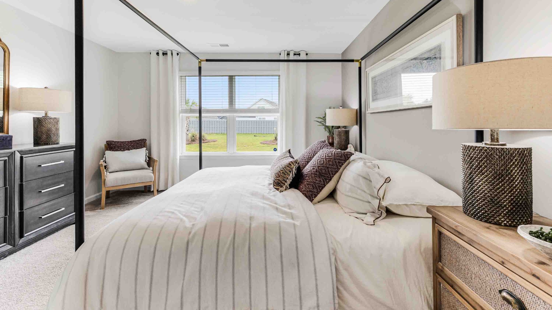 At the back, the Primary Suite provides privacy with a large walk-in closet and walk-in shower. This floor plan combines comfort and convenience, making it a great choice for those seeking an open layout.