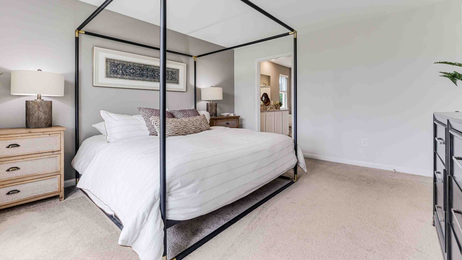 At the back, the Primary Suite provides privacy with a large walk-in closet and walk-in shower. This floor plan combines comfort and convenience, making it a great choice for those seeking an open layout.