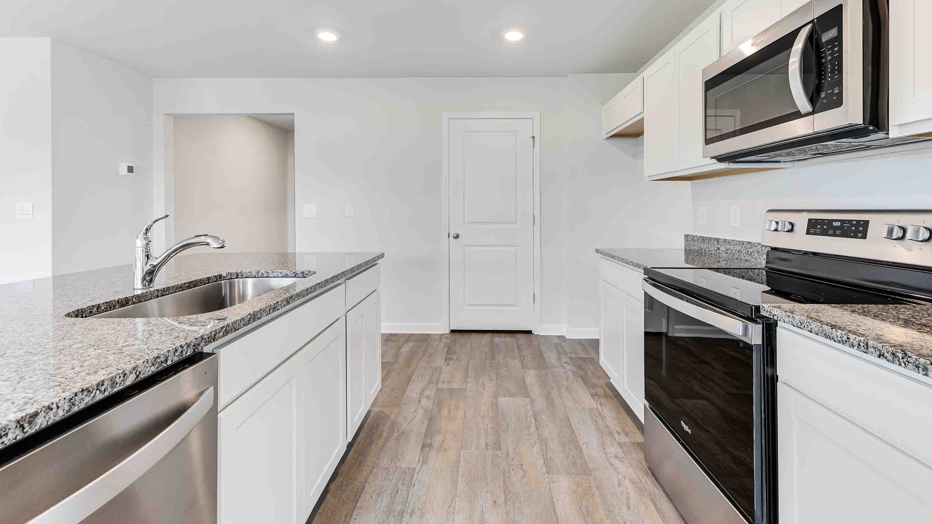 The kitchen features a large island, granite countertops, and stainless-steel appliances, which are sure to both turn heads and make meal prep easy. You’ll never be too far from the action with the living and dining area right there.