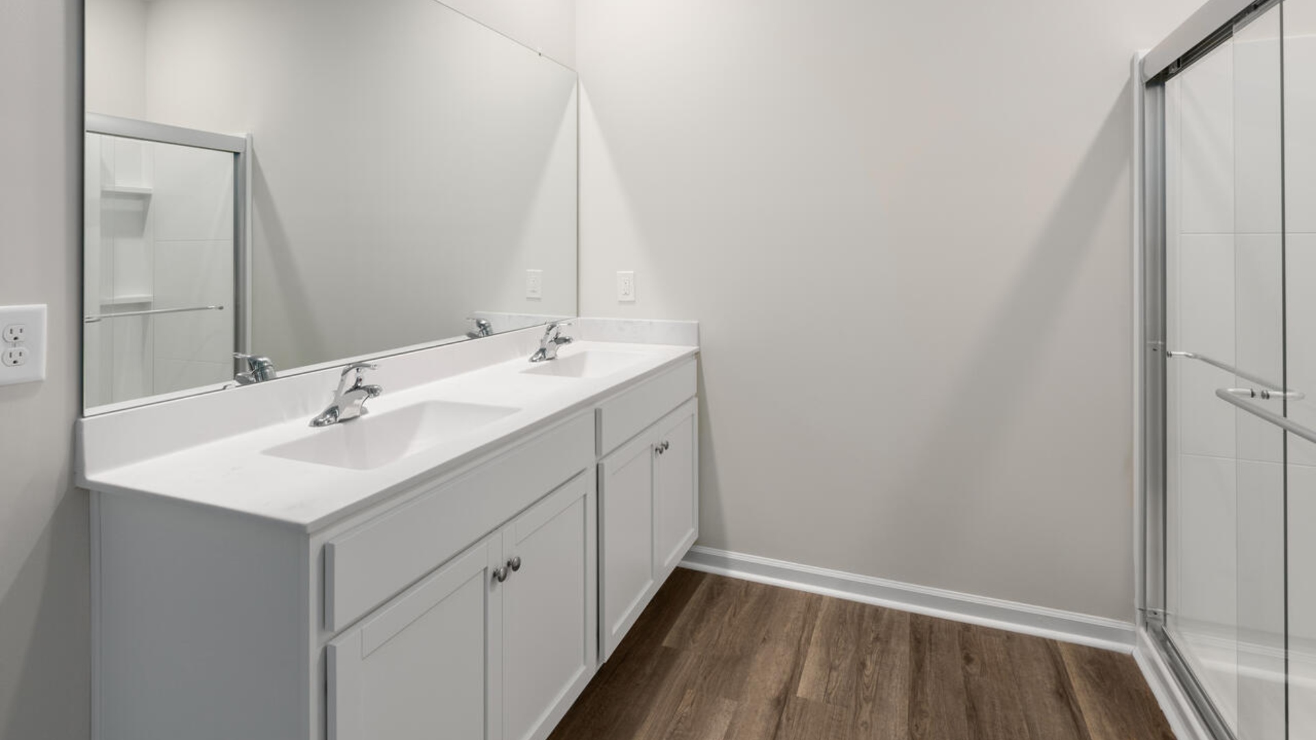 The Primary Suite offers a massive closet and a luxurious bathroom with a walk-in shower, linen closet, and dual vanity.